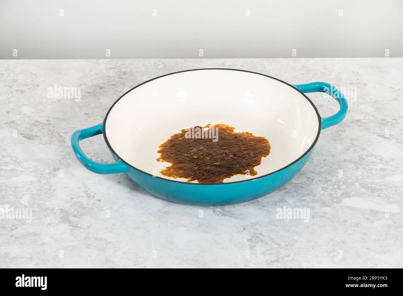 Cleaning cast iron blue enameled braiser Stock Photo - Alamy
