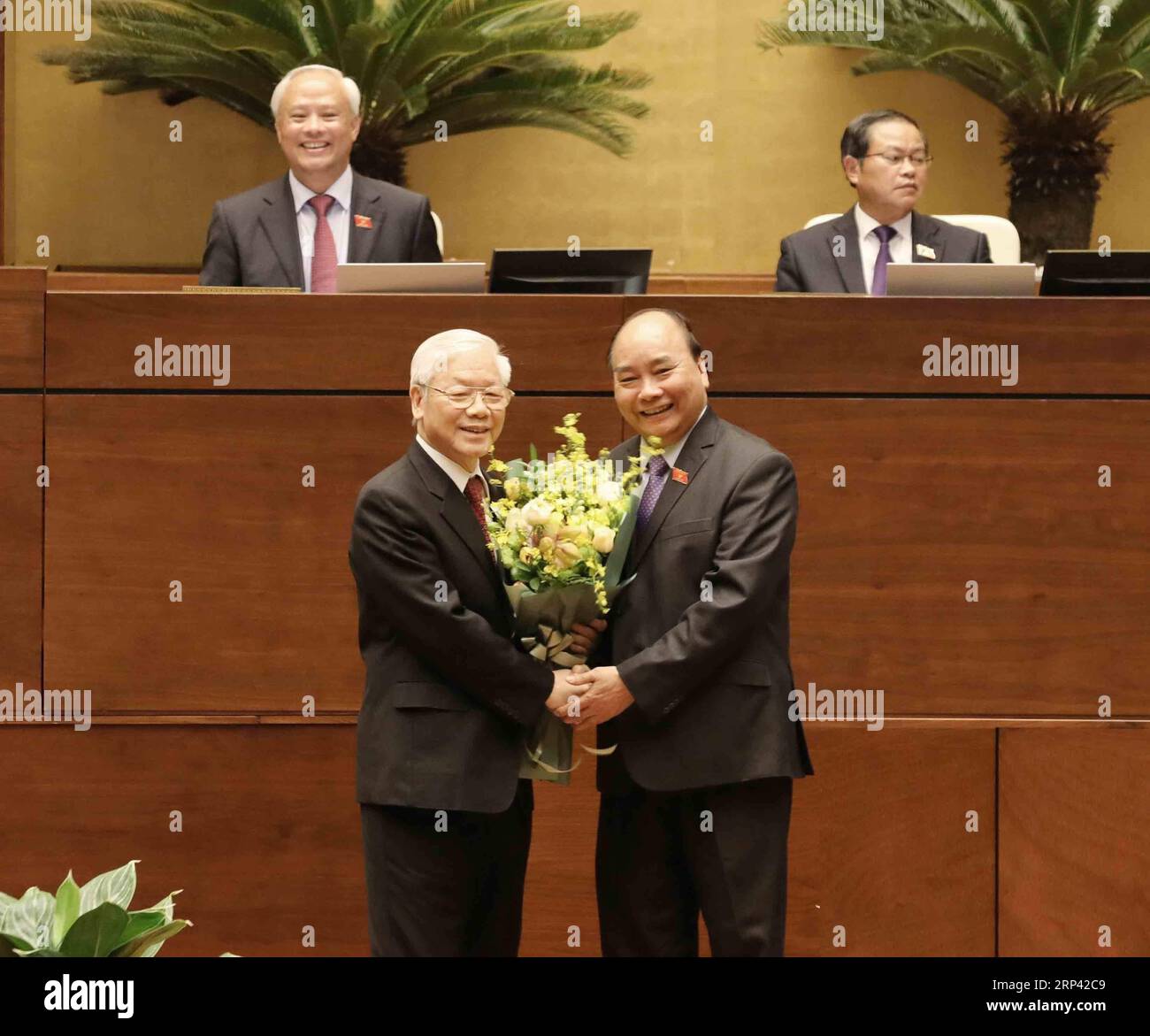 (181023) -- HANOI, Oct. 23, 2018 -- Vietnam s newly elected President Nguyen Phu Trong (L) is congratulated by Vietnamese Prime Minister Nguyen Xuan Phuc during a ceremony at the Parliament House in Hanoi, capital of Vietnam, on Oct. 23, 2018. Nguyen Phu Trong, general secretary of the Communist Party of Vietnam Central Committee (CPVCC), on Tuesday was elected president of Vietnam at the ongoing sixth session of the 14th National Assembly of Vietnam, the country s top legislature, Vietnam News Agency reported. )(dh) VIETNAM-HANOI-NEWLY ELECTED PRESIDENT-NGUYEN PHU TRONG VNA PUBLICATIONxNOTxIN Stock Photo