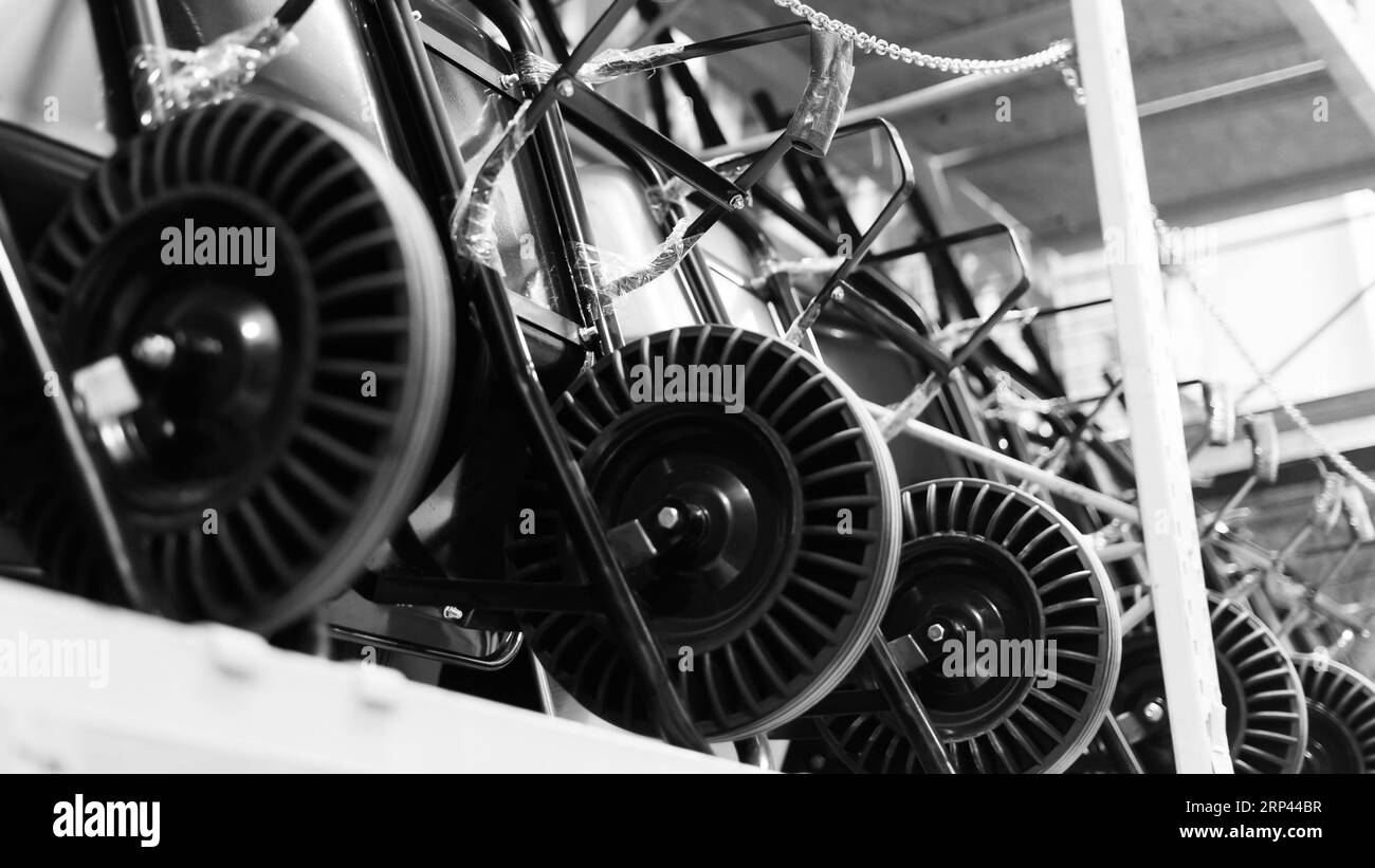 New black wheelbarrow in store, close up wheel, construction and garden