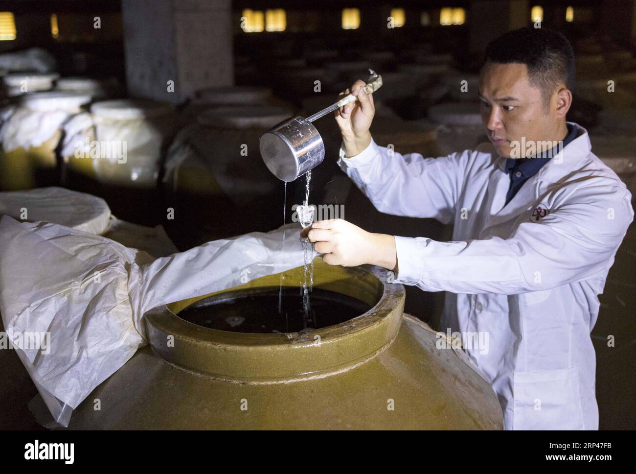 (181029) -- RENHUAI, Oct. 29, 2018 -- A worker checks liquor at a ...