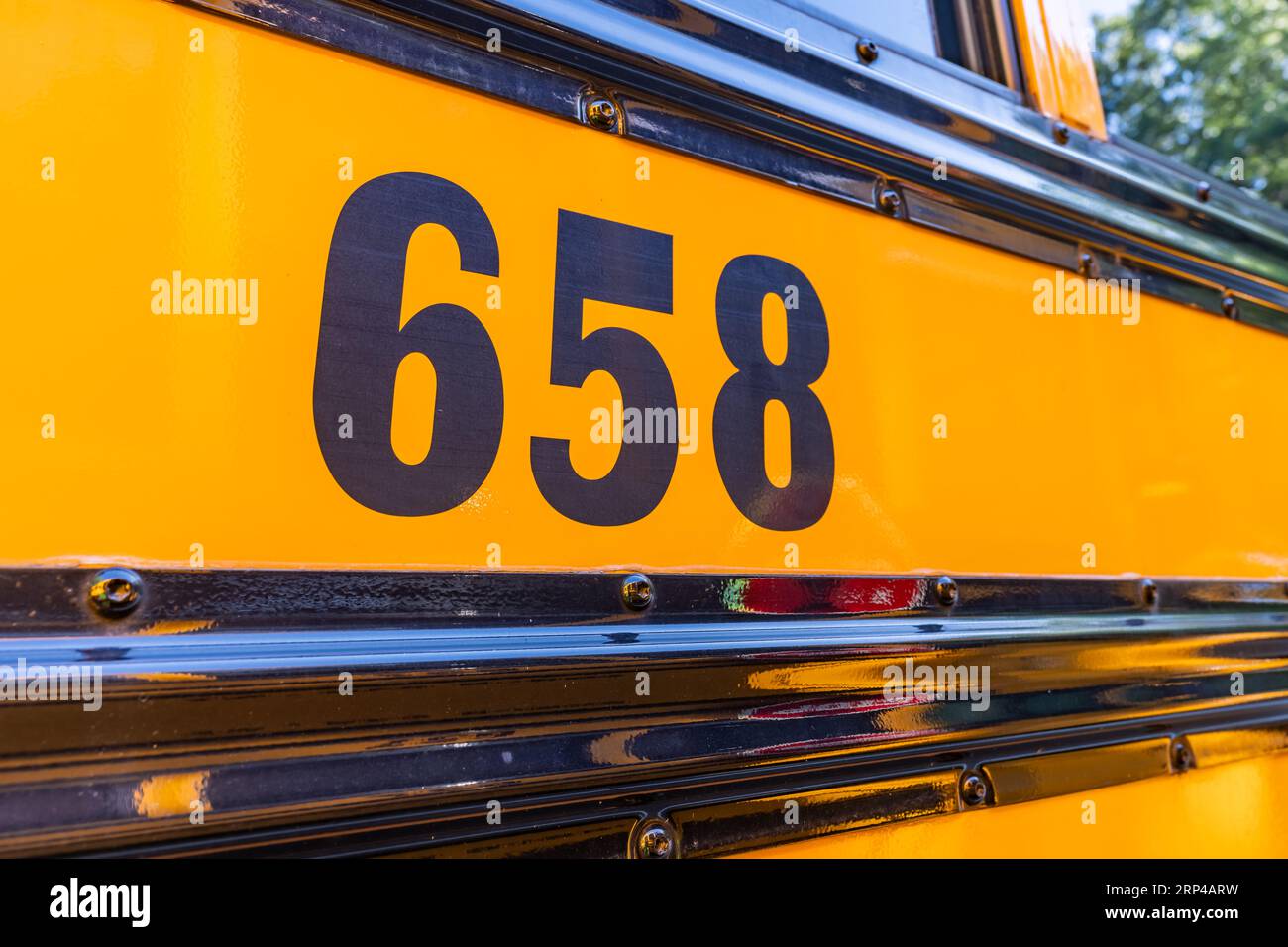 Side of a parked yellow school bus number 658 Stock Photo