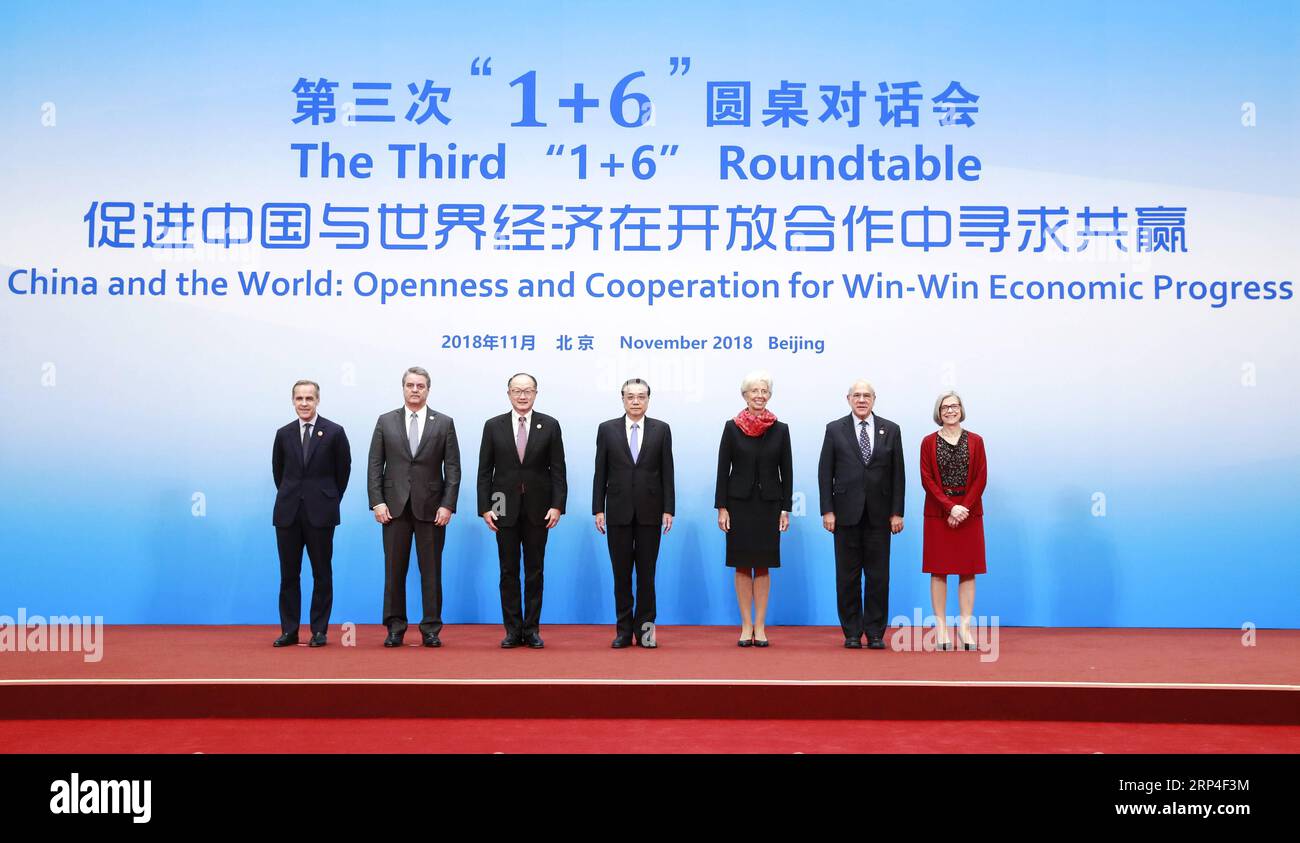 (181106) -- BEIJING, Nov. 6, 2018 -- Chinese Premier Li Keqiang (C), together with World Bank Group (WBG) President Jim Yong Kim (3rd L), International Monetary Fund (IMF) Managing Director Christine Lagarde (3rd R), World Trade Organization (WTO) Director-General Roberto Azevedo (2nd L), Organization for Economic Cooperation and Development (OECD) Secretary-General Angel Gurria (2nd R), Financial Stability Board (FSB) Chairman Mark Carney (1st L) and International Labor Organization (ILO) Deputy Director-General Deborah Greenfield (1st R), poses for a group photo before the third 1+6 Roundtab Stock Photo