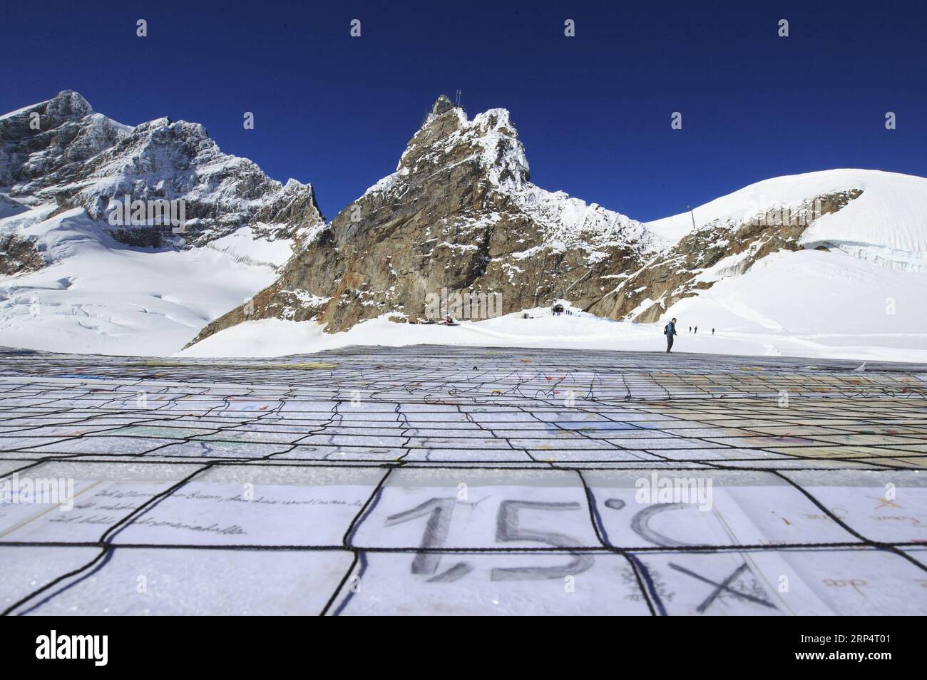 (181116) -- JUNGFRAUJOCH (SWITZERLAND), Nov. 16, 2018 -- A gigantic postcard with the writing of 1.5 degrees Celsius is seen on the Aletsch glacier under Jungfraujoch in Switzerland, on Nov. 16, 2018. The gigantic postcard breaking the Guinness World Records was staged just under the Swiss Jungfraujoch on Friday to raise awareness worldwide of the emergency and necessity to fight climate change. At the center of the postcard was a huge slogan reading STOP GLOBAL WARMING 1.5 ãC to signify the goal of limiting global warming to a maximum of 1.5 degrees Celsius, a target recently set by the Inter Stock Photo
