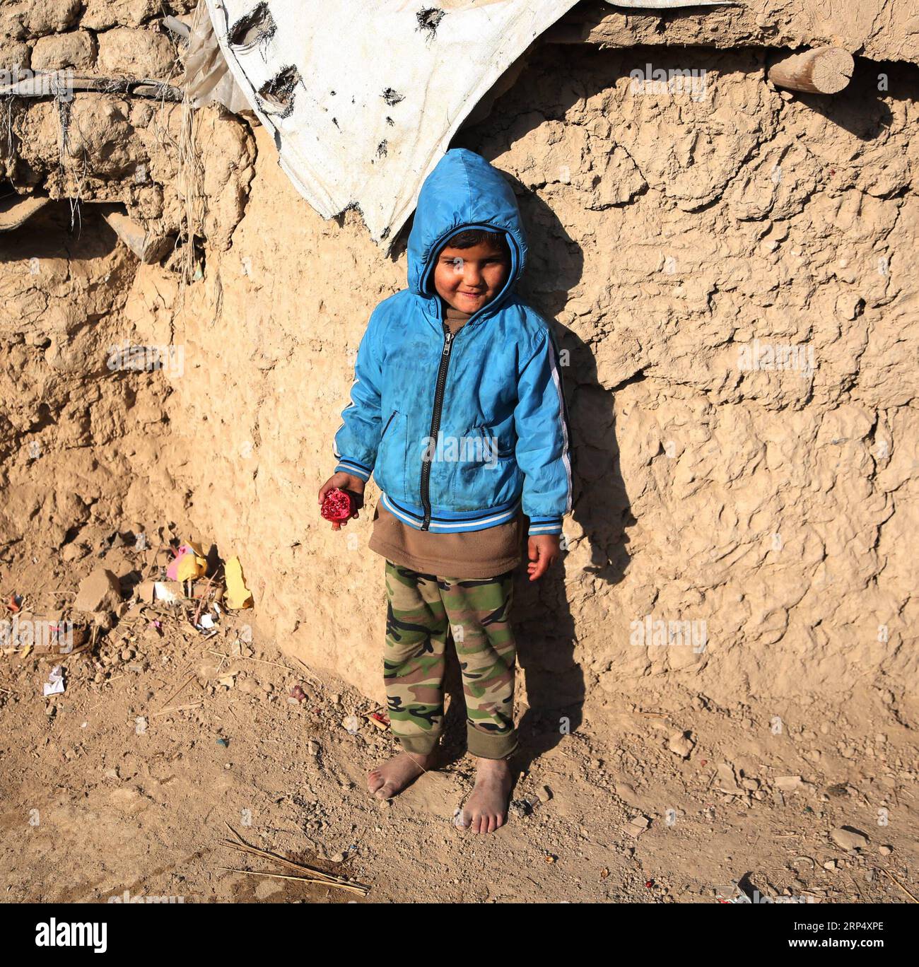 (181120) -- KABUL, Nov. 20, 2018 -- An Afghan child stands outside his mud house on World Children s Day in Kabul, capital of Afghanistan, Nov. 20, 2018. The United Nations Children s Fund (UNICEF) office in Afghanistan said on Monday that about 3.7 million Afghan children have no access to school due to insecurity and poverty in the country. ) AFGHANISTAN-KABUL-WORLD CHILDREN DAY RahmatxAlizadah PUBLICATIONxNOTxINxCHN Stock Photo