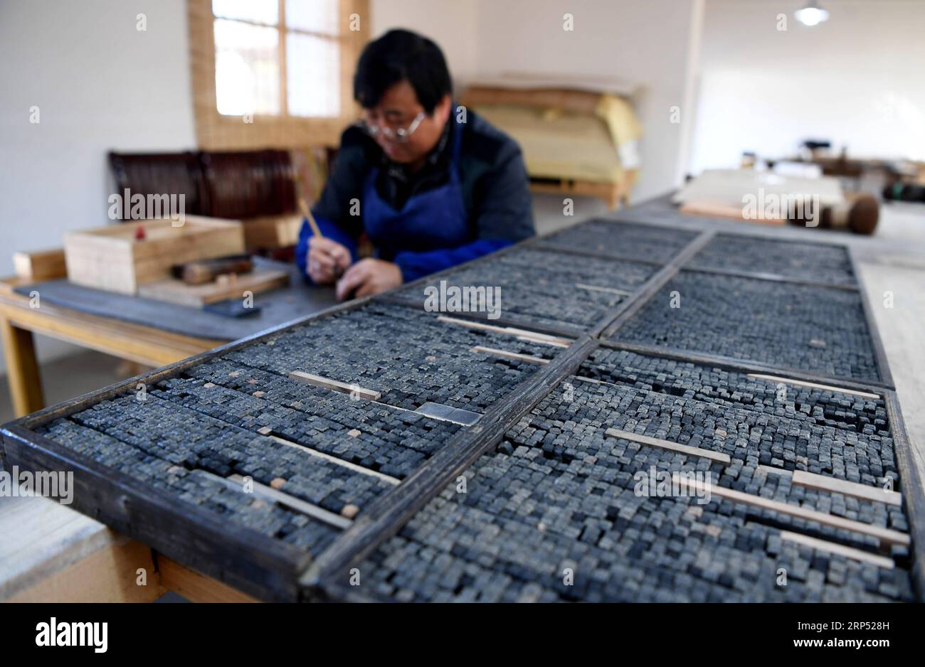 (181124) -- JINGXIAN, Nov. 24, 2018 -- Lei Shitai works in Chanshan Village of Qinxi Town, Jingxian County, in east China s Anhui Province, Nov. 23, 2018. Lei, 52, born in neighboring Jiangxi Province, started his career as a typography printer when he finished his apprenticeship with his uncle who he followed since he was 17. The traditional printing method witnessed an increasingly hard time in the recent years as a livelihood. It was in 2017 when he decided to move to Chanshan at the invitation of Kai Yuanhong, a local cabinet maker, to cooperate in a broader way. Lei is now working with th Stock Photo
