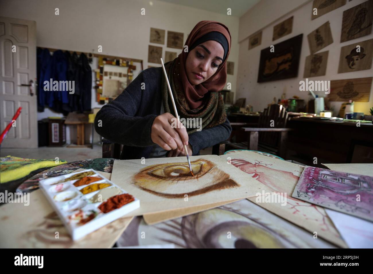 (181215) -- GAZA, Dec. 15, 2018 () -- Palestinian artist Walaa Abu al-Eish uses cooking spices to create an alternative painting in the southern Gaza Strip city of Rafah, on Dec. 9, 2018. A Palestinian woman from the Gaza Strip nontraditionally uses fruit and spices as tools for paintings in a sophisticated and interesting way. The experience of artist Walaa Abu al-Eish, 24, is unprecedented, especially as she developed her skills through online research after graduating from the Faculty of Fine Arts of a local university in Gaza. (/Stringer) MIDEAST-GAZA-FEMALE ARTIST-ALTERNATIVE PAINTING Xin Stock Photo