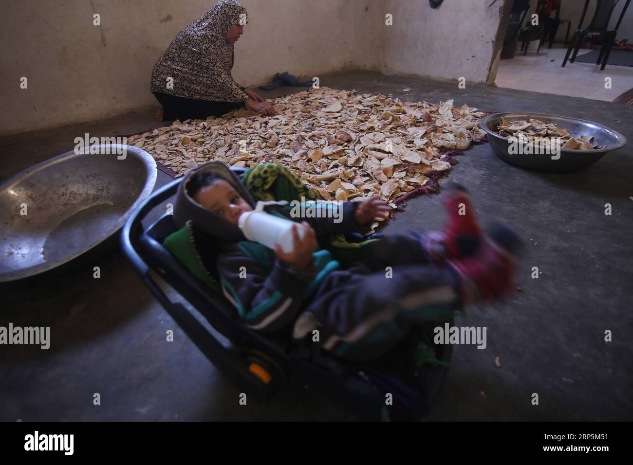 (181218) -- GAZA, Dec. 18, 2018 -- Palestinian woman Fayrouz al-A raj, 45, dries bread remains inside her house, in the southern Gaza Strip city of Khan Younis, on Dec. 18, 2018. Fayrouz al-A raj sells bread remains to livestock owners to feed their animals. ) MIDEAST-GAZA-BREAD-REMAINS KhaledxOmar PUBLICATIONxNOTxINxCHN Stock Photo