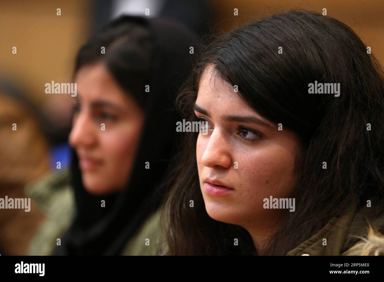 (181219) -- ATHENS, Dec. 19, 2018 -- Migrant students are seen attending the press conference of Greek Minister for Migration Policy Dimitrios Vitsas on the occasion of the International Migrants Day in Athens, Greece, on Dec. 18, 2018. Greek society has sent a clear message of solidarity to people seeking a better life away from their homelands, Greek officials told the press conference on Tuesday on the occasion of International Migrants Day, observed on Dec. 18 each year since 2000. During the eight years of the debt crisis, Greece has been working systematically towards the smooth integrat Stock Photo