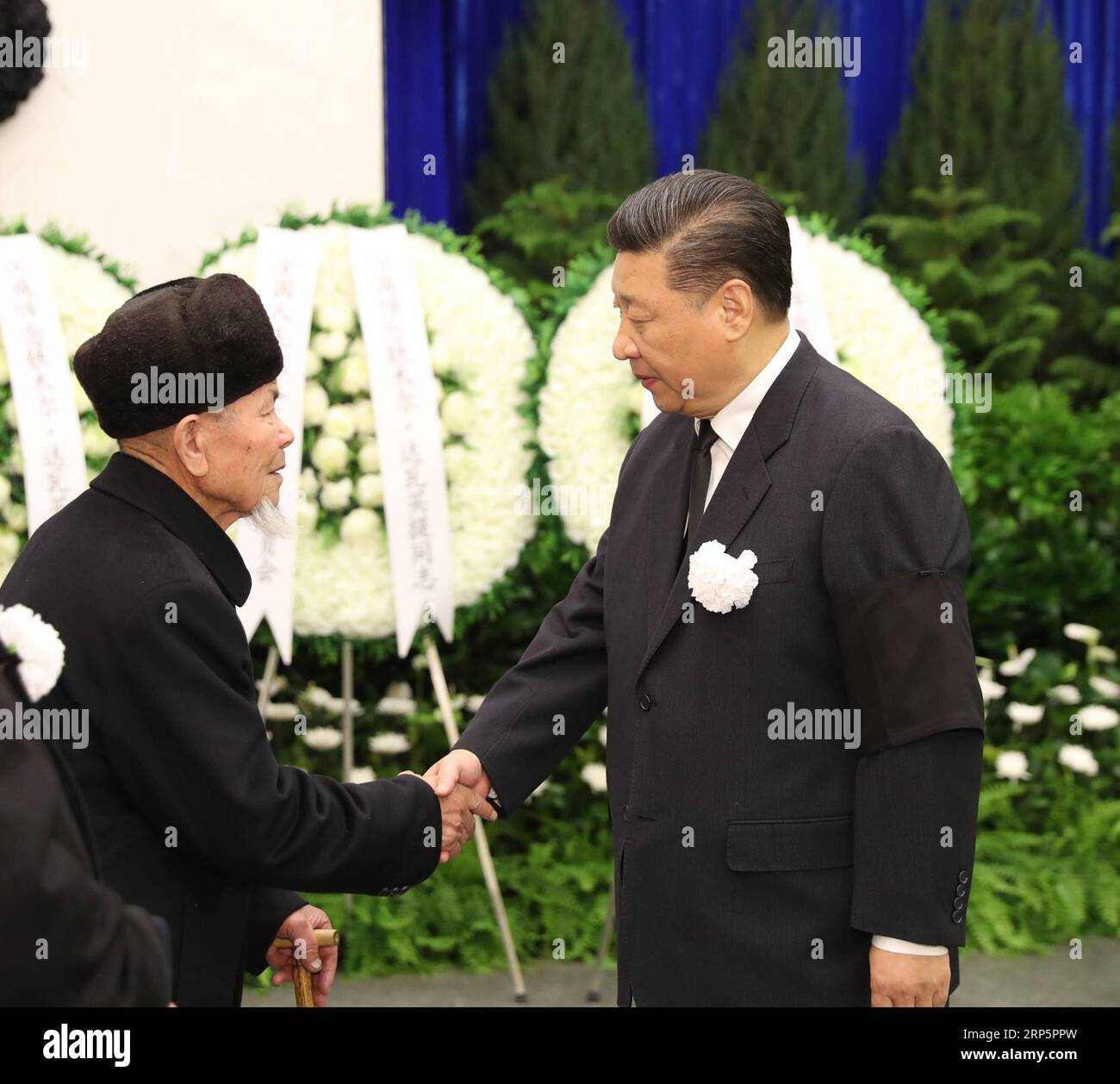 (181221) -- BEIJING, Dec. 21, 2018 -- Chinese President Xi Jinping (R) shakes hands with a family member of Tomur Dawamat, former vice chairman of the National People s Congress (NPC) Standing Committee, at the funeral of Dawamat at the Babaoshan Revolutionary Cemetery in Beijing, capital of China, Dec. 21, 2018. Dawamat died at the age of 92 on Dec. 19 in Beijing. Xi Jinping, Li Keqiang, Li Zhanshu, Wang Yang, Wang Huning, Zhao Leji, Han Zheng and Wang Qishan as well as other senior officials paid their final respects at the service at Babaoshan Revolutionary Cemetery in Beijing on Friday. ) Stock Photo
