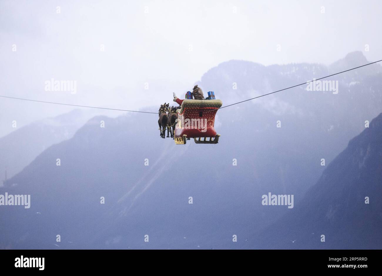 (181222) -- MONTREUX (SWITZERLAND), Dec. 22, 2018 -- A Santa Claus waves to the crowd from his flying sleigh drawn by reindeers over Lake Leman at sunset in Montreux, Switzerland, on Dec. 22, 2018. The flying Santa Claus stunt show is part of promotional activities by the Christmas market in Montreux, which is one of the most famous and biggest markets of its kind in Switzerland. ) SWITZERLAND-MONTREUX-SANTA CLAUS-FLYING SLEIGH NiexXiaoyang PUBLICATIONxNOTxINxCHN Stock Photo
