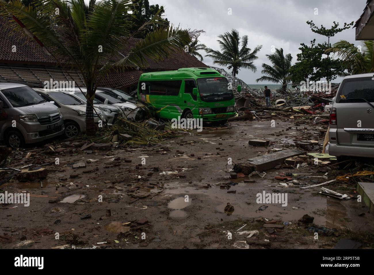 (181223) -- PANDEGLANG, Dec. 23, 2018 -- Vehicles are seen among the debris after a tsunami hit Sunda Strait in Pandeglang, Banten province, in Indonesia, Dec. 23, 2018. The total casualty of a tsunami triggered by the eruption of Krakatau Child volcano has increased to 168 people in coastal areas of Sunda Strait of western Indonesia, disaster agency official said here on Sunday. The catastrophe killed at least 168 people, wounded at least 745 ones and collapsed a total of 430 houses and nine hotels, and caused damages to scores of ships. ) INDONESIA-PANDEGLANG-TSUNAMI-AFTERMATH VerixSanovri P Stock Photo
