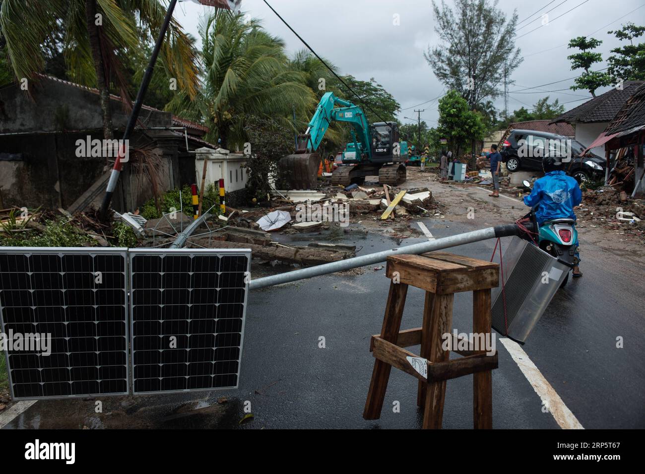 (181223) -- PANDEGLANG, Dec. 23, 2018 -- An excavator cleans road from debris after a tsunami hit Sunda Strait in Pandeglang, Banten province, in Indonesia, Dec. 23, 2018. The total casualty of a tsunami triggered by the eruption of Krakatau Child volcano has increased to 168 people in coastal areas of Sunda Strait of western Indonesia, disaster agency official said here on Sunday. The catastrophe killed at least 168 people, wounded at least 745 ones and collapsed a total of 430 houses and nine hotels, and caused damages to scores of ships. ) INDONESIA-PANDEGLANG-TSUNAMI-AFTERMATH VerixSanovri Stock Photo