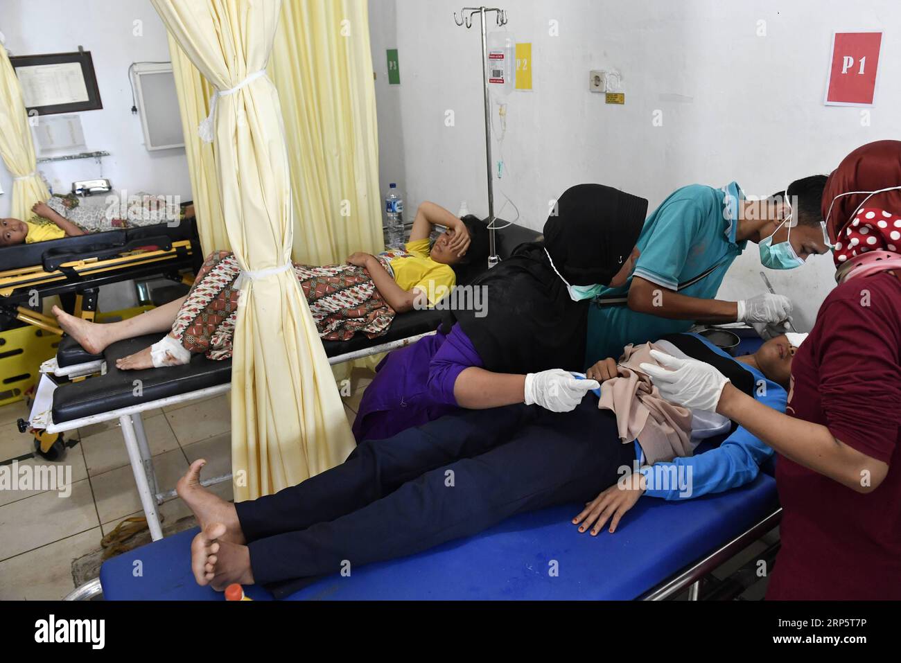 (181223) -- BANTEN, Dec. 23, 2018 -- Injured people receive treatment at Cinangka clinic after a tsunami hit Sunda Strait in Pandeglang, Banten province, in Indonesia, Dec. 23, 2018. The total casualty of a tsunami triggered by the eruption of Krakatau Child volcano has increased to 168 people in coastal areas of Sunda Strait of western Indonesia, disaster agency official said here on Sunday. The catastrophe killed at least 168 people, wounded at least 745 ones and collapsed a total of 430 houses and nine hotels, and caused damages to scores of ships. ) INDONESIA-BANTEN-TSUNAMI-AFTERMATH Wahyu Stock Photo