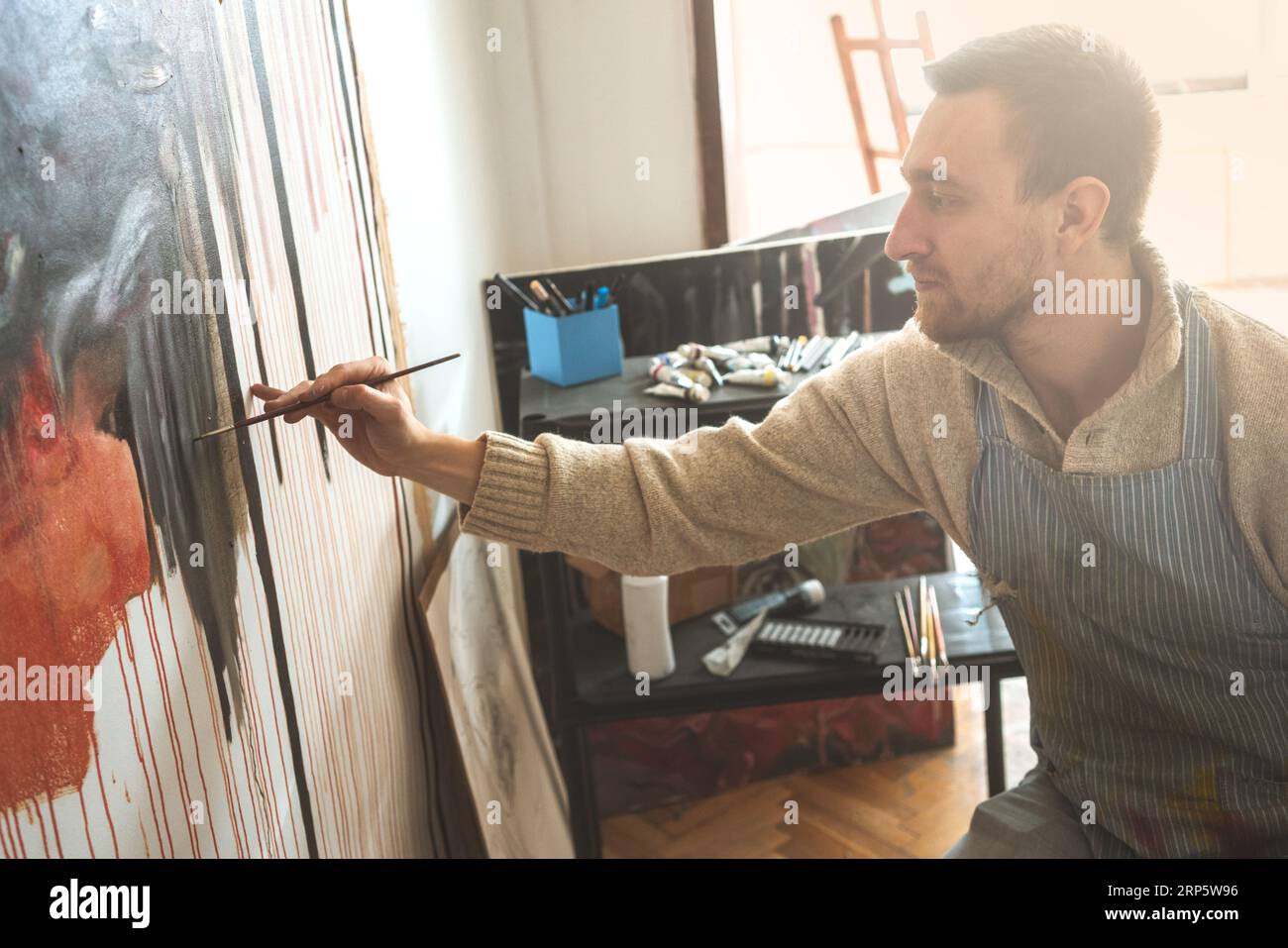Male artist holding painting hi-res stock photography and images - Alamy