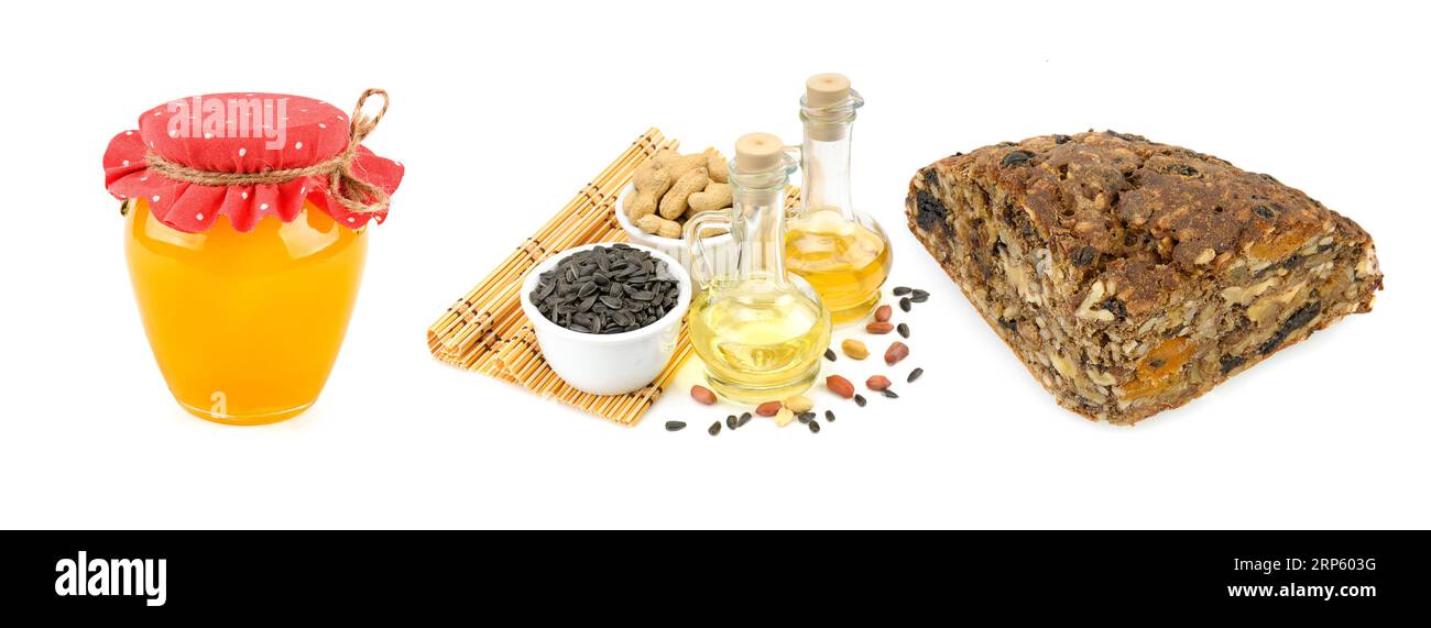 Bread, honey, nuts and seeds isolated on white background. Collage of ingredients for scandinavian bread. Wide photo. Stock Photo