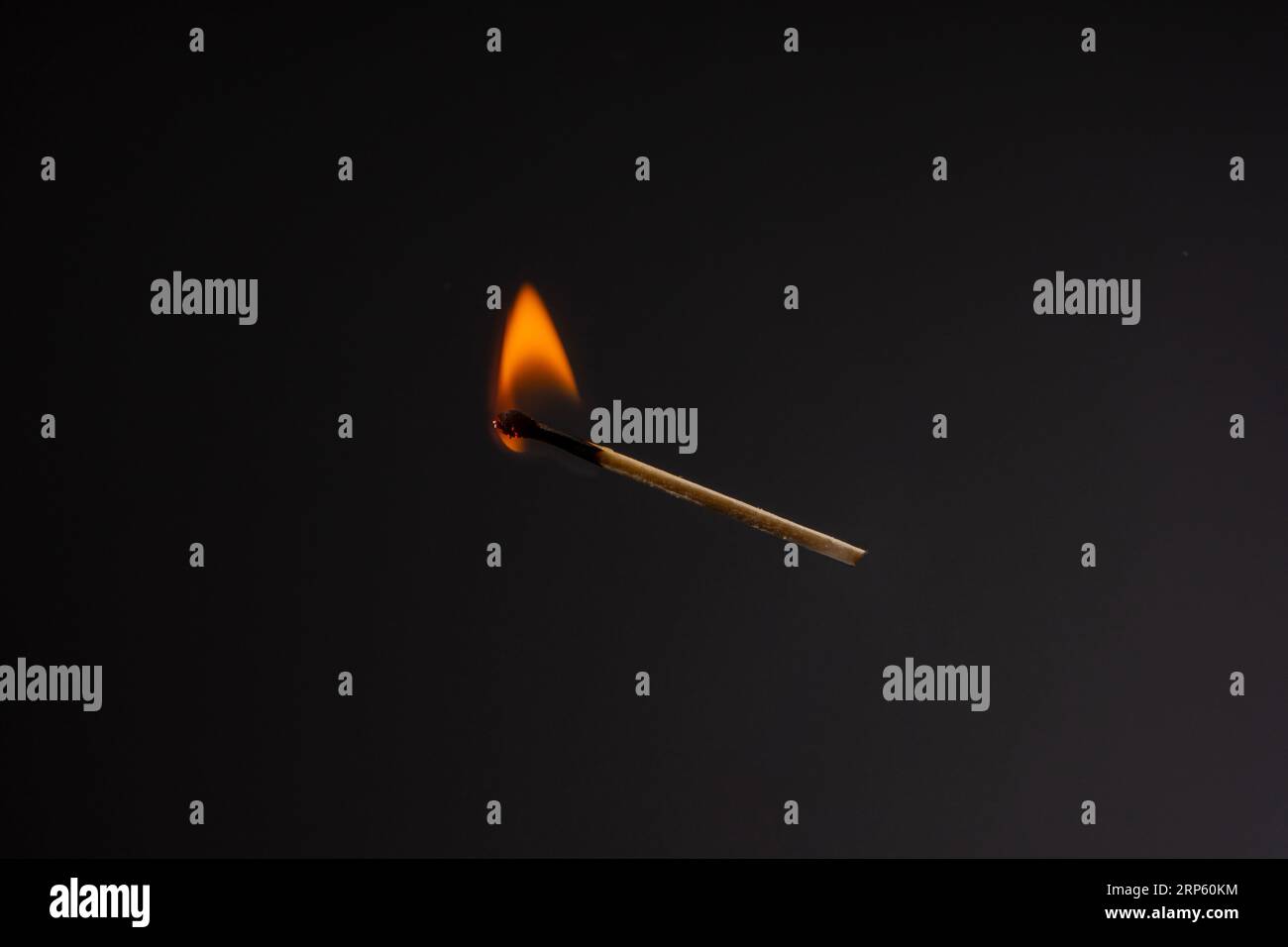 Lit and falling match on a black background Stock Photo - Alamy