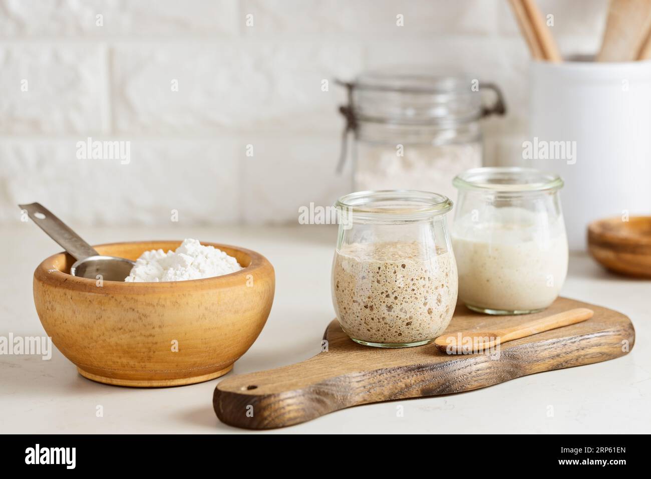 Glass jars with active sourdough starter on table Stock Photo Alamy