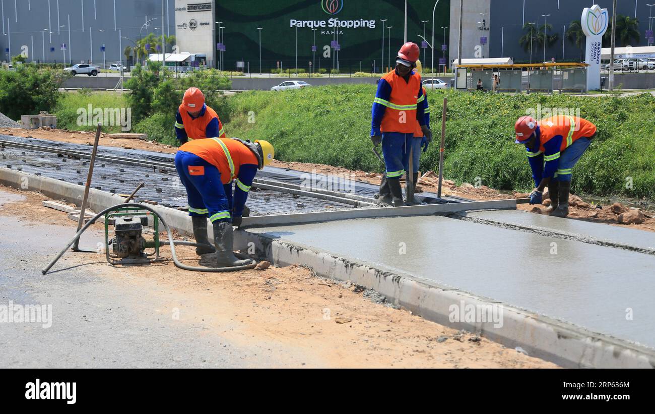 lauro de freitas, bahia, brazil - august 30, 2023: Construction workers are seen making concrete pavement on a sidewalk. Stock Photo