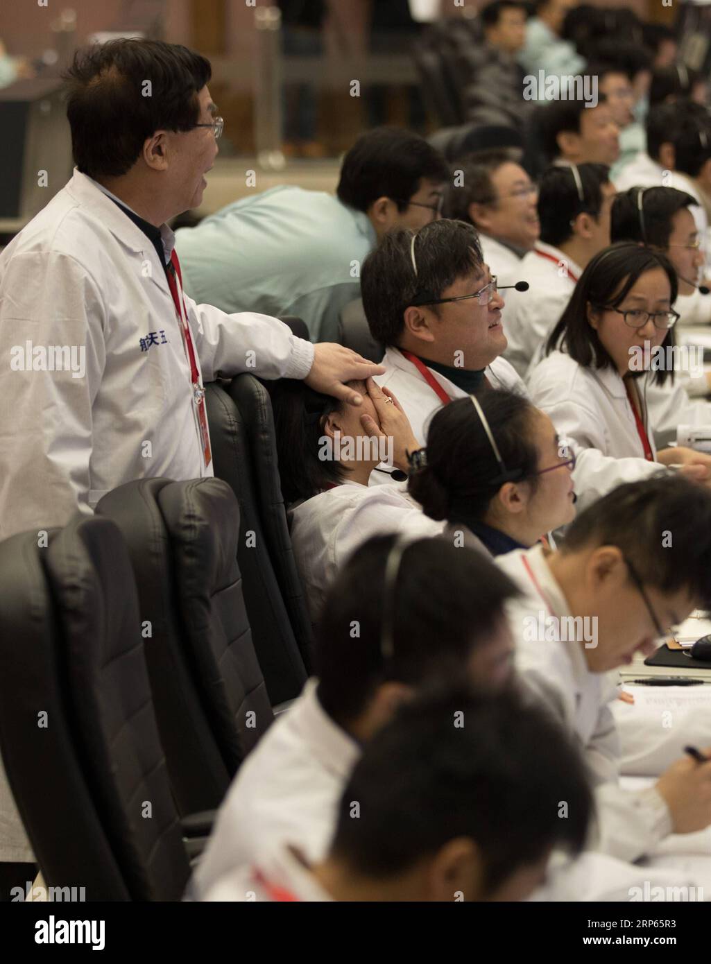 (190103) -- BEIJING, Jan. 3, 2019 -- Technicians celebrate after the landing of Chang e-4 lunar probe, at the Beijing Aerospace Control Center (BACC) in Beijing, capital of China, Jan. 3, 2019. China s Chang e-4 probe touched down on the far side of the moon Thursday, becoming the first spacecraft soft-landing on the moon s uncharted side never visible from Earth. The probe, comprising a lander and a rover, landed at the preselected landing area on the far side of the moon at 10:26 a.m. Beijing Time (0226 GMT), the China National Space Administration announced. ) CHINA-CHANG E-LUNAR PROBE-MOON Stock Photo