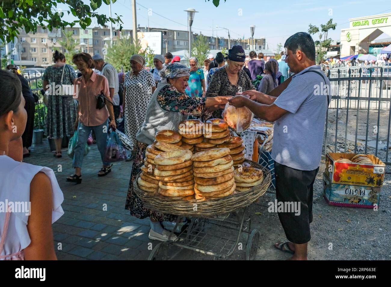 Shymkent, Kazakhstan - August 26, 2023: A bread seller at the Qyrgy Bazar in Shymkent, Kazakhstan. Stock Photo
