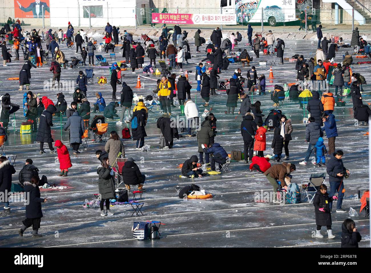 (190105) -- HWACHEON, Jan. 5, 2019 -- People fish for trouts on a frozen river during the Sancheoneo Ice Festival in Hwacheon, South Korea, Jan. 5, 2019. As one of the biggest winter events in South Korea, the annual three-week festival draws people to the frozen Hwacheon river, where organizers drill fishing holes in the ice and release trouts into the river during the festival period. This year the festival lasts from Jan. 5 to Jan. 27. ) SOUTH KOREA-HWACHEON-SANCHEONEO ICE FESTIVAL WangxJingqiang PUBLICATIONxNOTxINxCHN Stock Photo