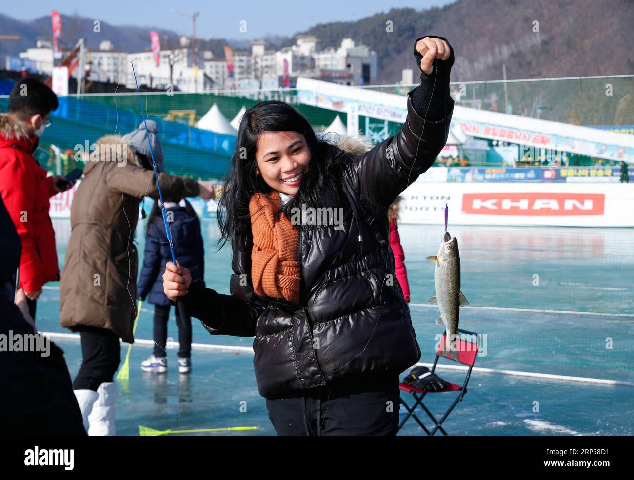 (190105) -- HWACHEON, Jan. 5, 2019 -- A woman shows a trout she caught on a frozen river during the Sancheoneo Ice Festival in Hwacheon, South Korea, Jan. 5, 2019. As one of the biggest winter events in South Korea, the annual three-week festival draws people to the frozen Hwacheon river, where organizers drill fishing holes in the ice and release trouts into the river during the festival period. This year the festival lasts from Jan. 5 to Jan. 27. ) SOUTH KOREA-HWACHEON-SANCHEONEO ICE FESTIVAL WangxJingqiang PUBLICATIONxNOTxINxCHN Stock Photo