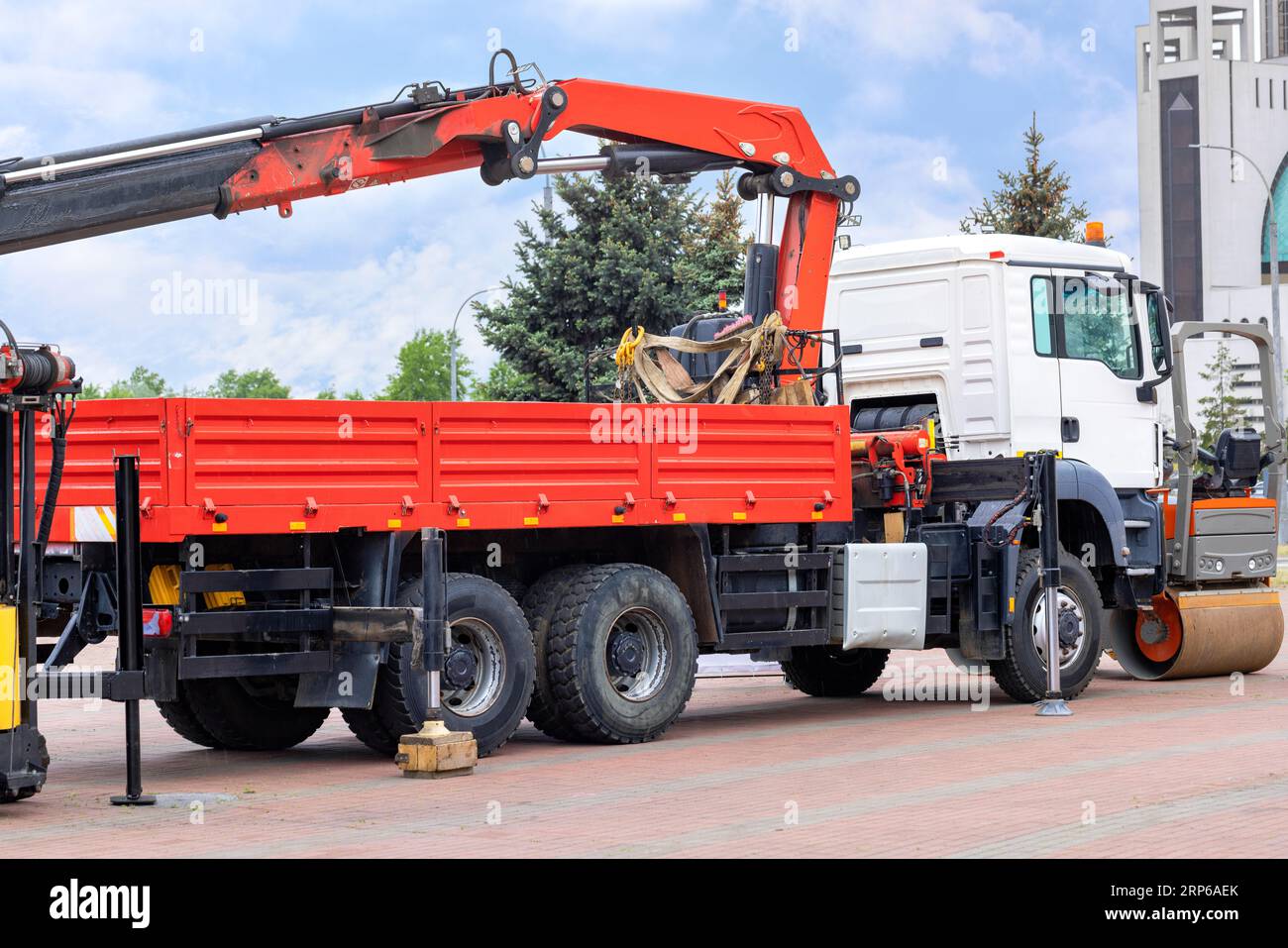 Loading and unloading machine of red color stands in the transport parking of the construction exhibition. Stock Photo