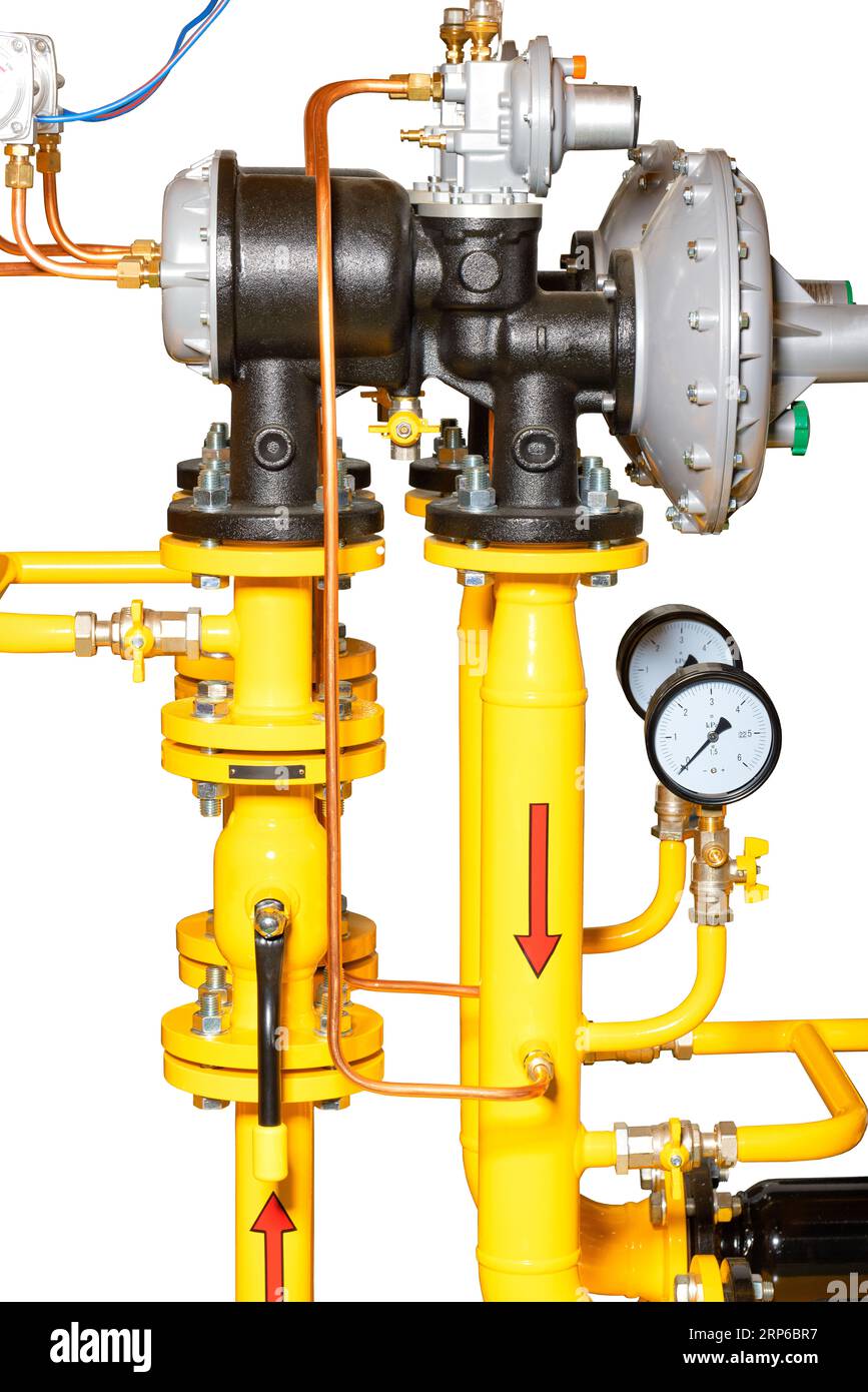 A fragment of a gas control station with valves, pressure gauges, and gas pressure stabilizers. The image is isolated on a white background. Stock Photo