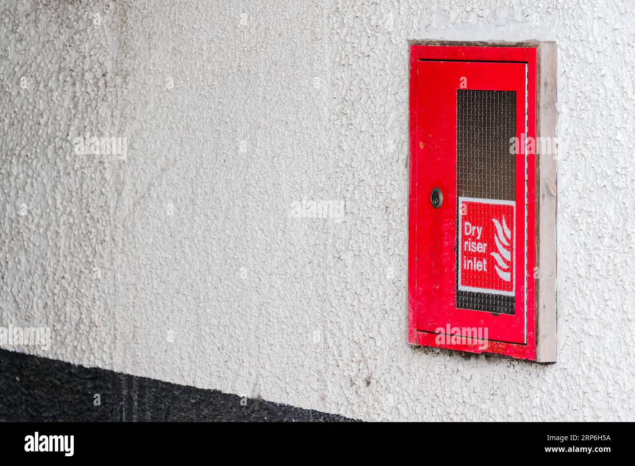 Dry riser red inlet box and sign at wall Stock Photo Alamy