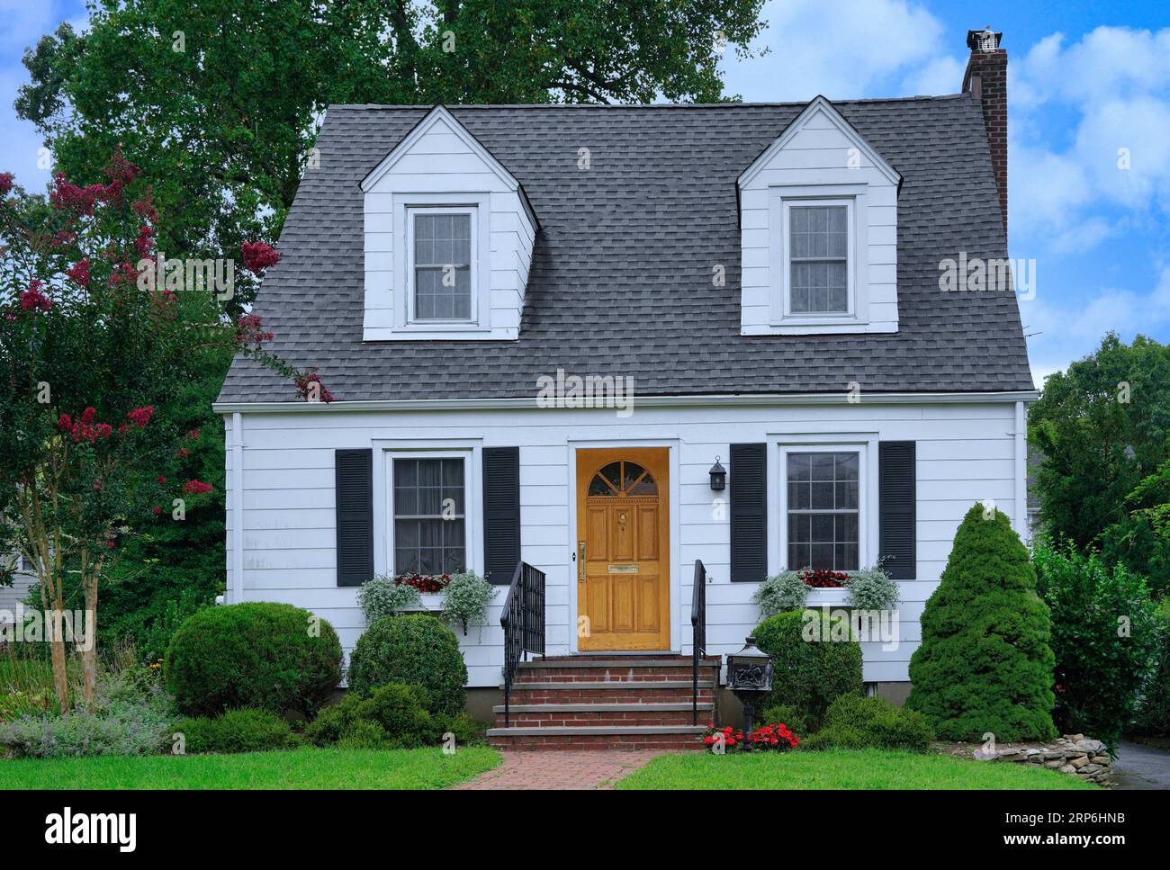 Small white clapboard house with dormer windows Stock Photo