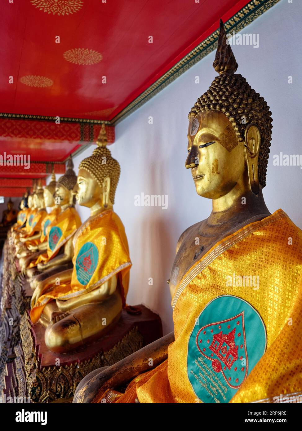 A series of golden Buddha statues in a temple Stock Photo - Alamy