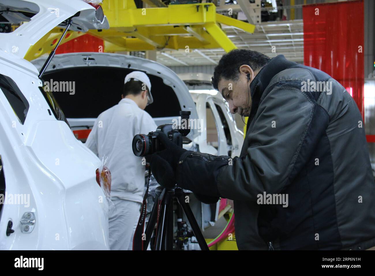 (190117) -- URUMQI, Jan. 17, 2019 () -- Sherif Sonbol Tadros Sonbol, vice editor-in-chief of Egypt s Al-Ahram Weekly , shoots at the factory of the Guangzhou Automobile Group Co., ltd. (GAC Group) in Urumqi, capital of northwest China s Xinjiang Uygur Autonomous Region, Jan. 10, 2019. A media group consisting of people from six countries praised the development and stability of Xinjiang after visiting the region. The Silk Road Celebrity China Tour was held from Jan. 9 to 16 in Xinjiang, with 12 media representatives from Egypt, Turkey, Pakistan, Afghanistan, Bangladesh and Sri Lanka visiting l Stock Photo