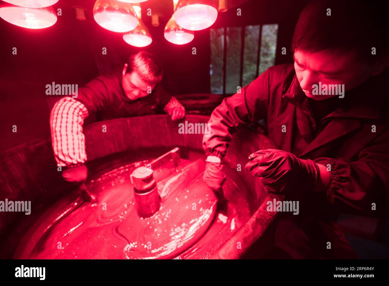(190119) -- LONGQUAN, Jan. 19, 2019 (Xinhua) -- Wu Rongqiang (R) and his apprentice make lacquer at his studio in Niutouling Village, Longquan City of east China s Zhejiang Province, Jan. 15, 2019. Wu Rongqiang, a Longquan native aged 45, started exploring traditional lacquer art since 2012. In 2017, he moved his family to an old house deep in the mountains in Longquan in order to do more experiments in lacquer undisturbed. He uses lacquer to repair broken porcelain and to create lacquerware. Also, he experiments on the production of various lacquers. I feel so pleased to return to my hometown Stock Photo