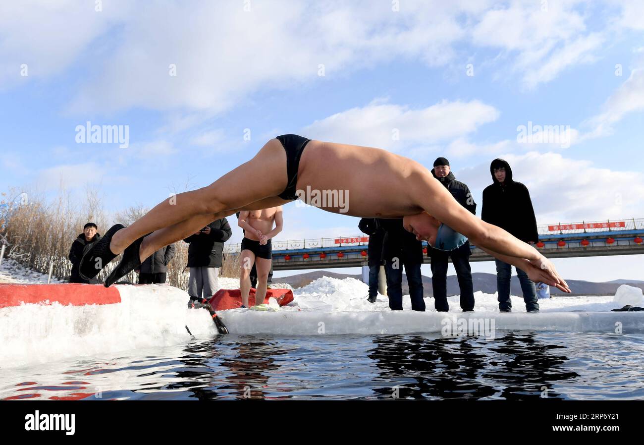 (190122) -- JAGDAQI, Jan. 22, 2019 (Xinhua) -- Xu Jingrui, a memeber of North Polar Bear Winter Swimming Club jumps into the Ganhe River in Jagdaqi of northeastern China s Heilongjiang Province, Jan. 22, 2019. Jagdaqi, located in northwest of Heilongjiang Province and east part of the Great Khingan Mountains, experiences cold weather in winter. The local North Polar Bear Winter Swimming Club, established in the year of 1998, keeps training every winter regardless of the low temperature. There are 92 members in the club at present and 15 of them are women winter-simmer lovers. (Xinhua/Wang Yugu Stock Photo