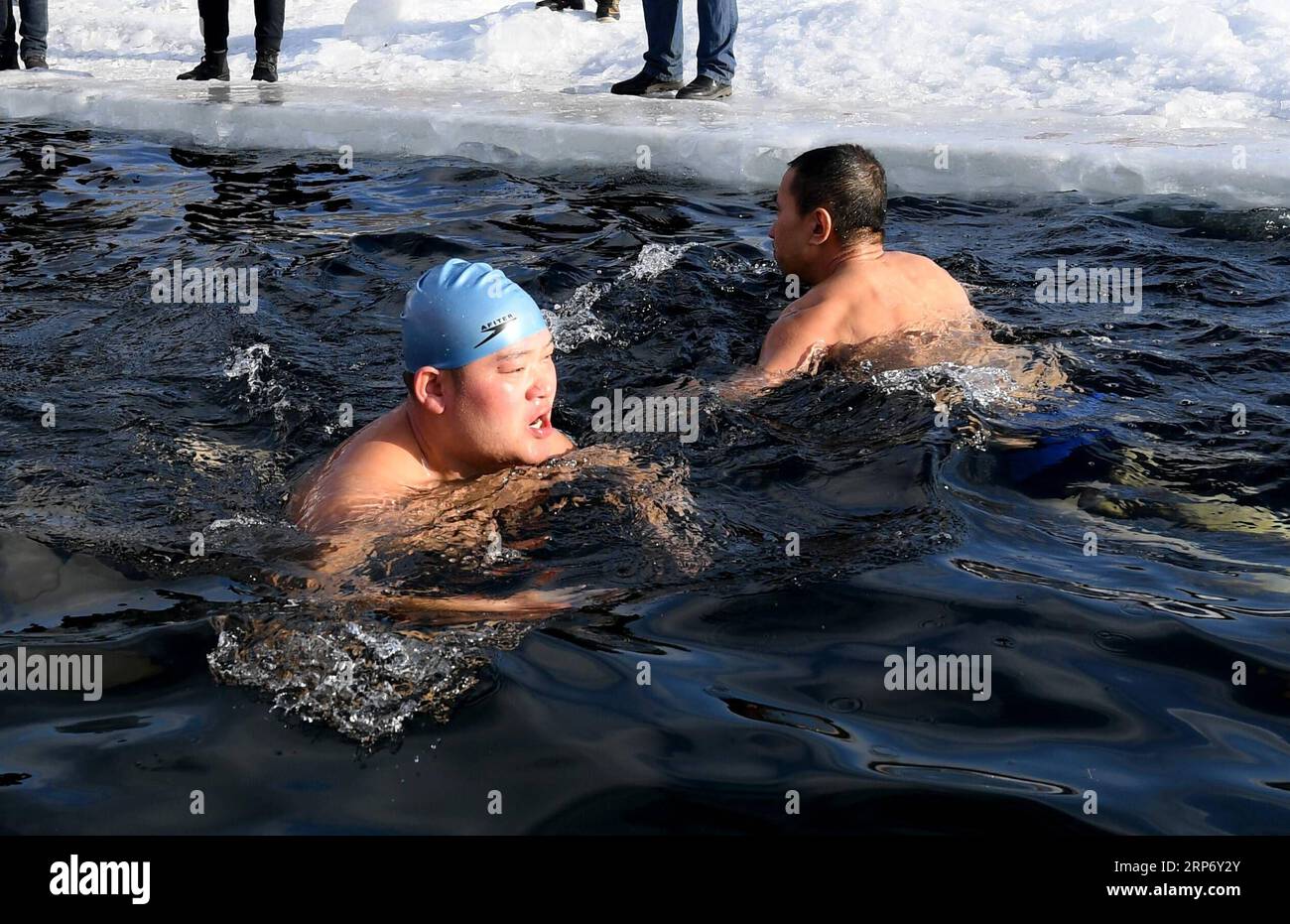 (190122) -- JAGDAQI, Jan. 22, 2019 (Xinhua) -- Xu Jingrui, a memeber of North Polar Bear Winter Swimming Club swims in the Ganhe River in Jagdaqi of northeastern China s Heilongjiang Province, Jan. 22, 2019. Jagdaqi, located in northwest of Heilongjiang Province and east part of the Great Khingan Mountains, experiences cold weather in winter. The local North Polar Bear Winter Swimming Club, established in the year of 1998, keeps training every winter regardless of the low temperature. There are 92 members in the club at present and 15 of them are women winter-simmer lovers. (Xinhua/Wang Yuguo) Stock Photo