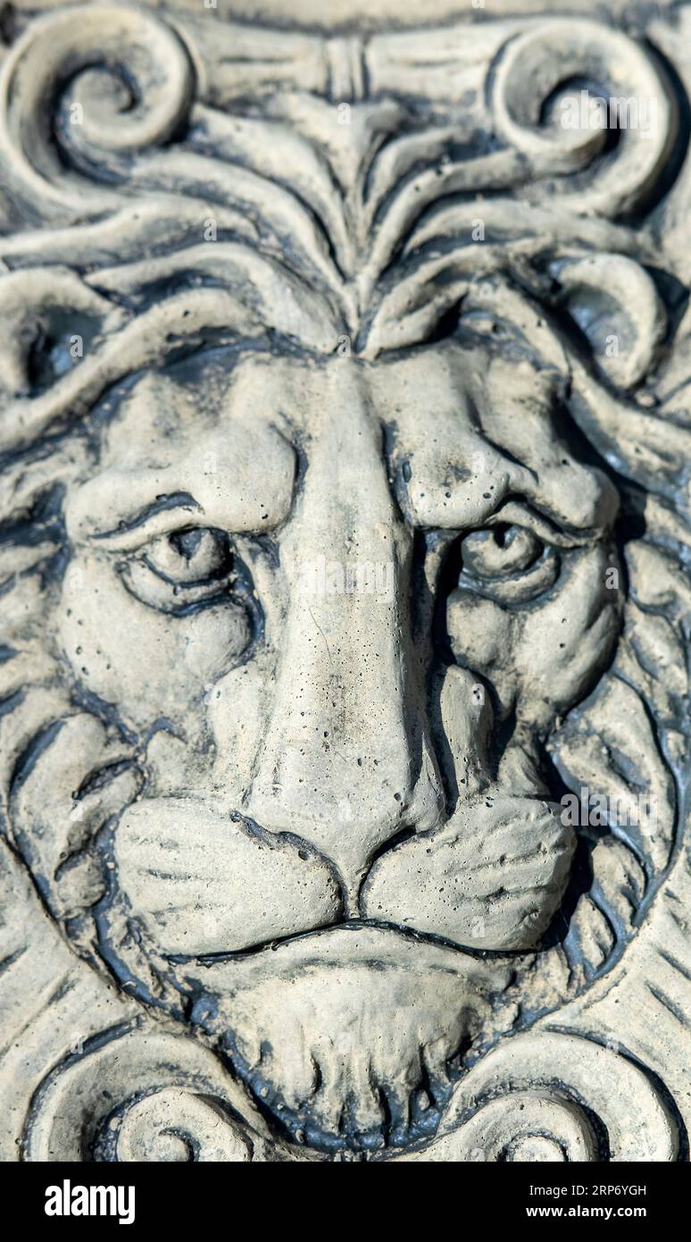 lions face mask made from stone for a garden ornament. close of of model of lion face. Stock Photo