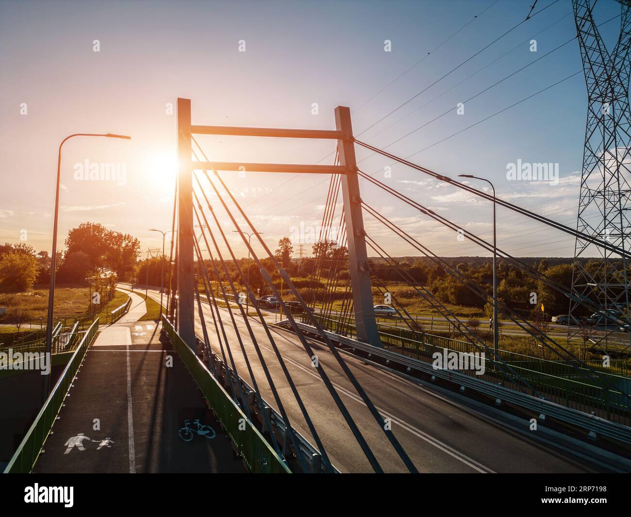 modern metal cable bridge over Bystrzyca river, sunset, Zeglarska street, Lublin Stock Photo