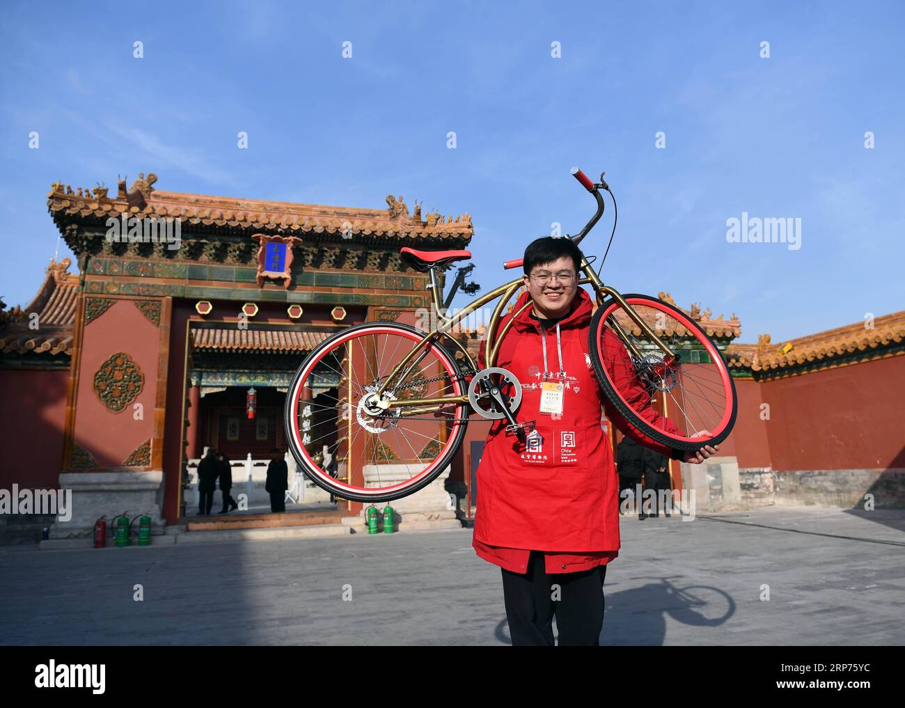 (190129) -- BEIJING, Jan. 29, 2019 (Xinhua) -- A staff member shows a special edition of Phoenix bicycle at the Palace Museum in Beijing, capital of China, Jan. 28, 2019. About 150 Chinese time-honored brands, selected from some Chinese provinces and municipalities, are exhibited at a fair in the Palace Museum during the Spring Festival. The histories of many of the Chinese time-honored brands, ranging from local delicacies, liquors, health products to silk and handicrafts, can be traced back to the Qing Dynasty (1644-1911) when their products were exclusive tributes to the imperial family. Th Stock Photo