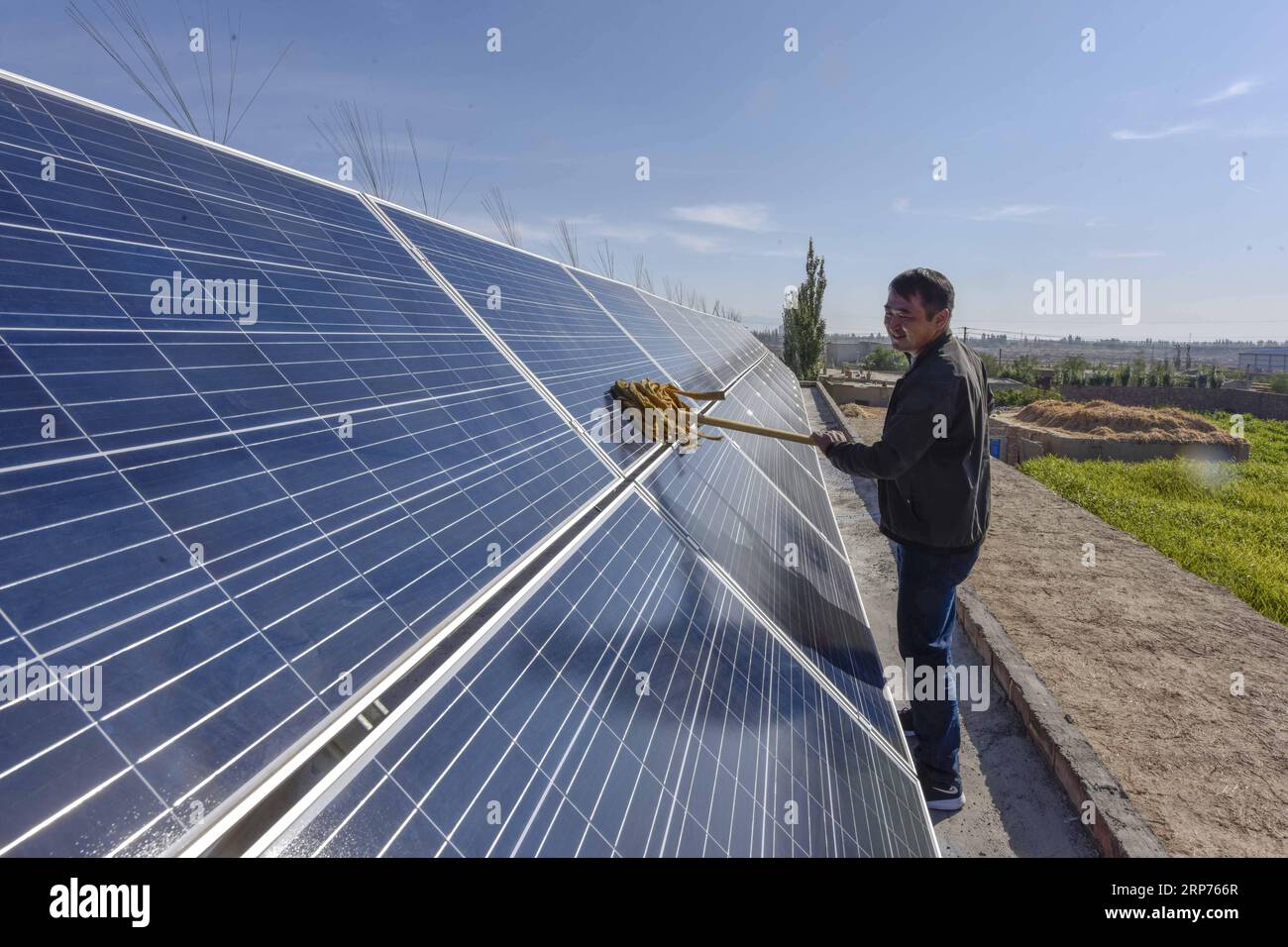 (190129) -- BEIJING, Jan. 29, 2019 (Xinhua) -- Villager Pan Linqi cleans solar panels in Hami, northwest China s Xinjiang Uygur Autonomous Region, Sept. 21, 2018. New energy power generation saw double digit growth last year in northwest China s Xinjiang Uygur Autonomous Region amid efforts to reduce coal consumption to improve the energy mix. Wind and solar power generation rose 15.2 percent and 13.6 percent to 36 billion kwh and 11.7 billion kwh respectively, according to the regional development and reform commission. It said 22.9 percent of installed wind power generating capacity and 15.5 Stock Photo
