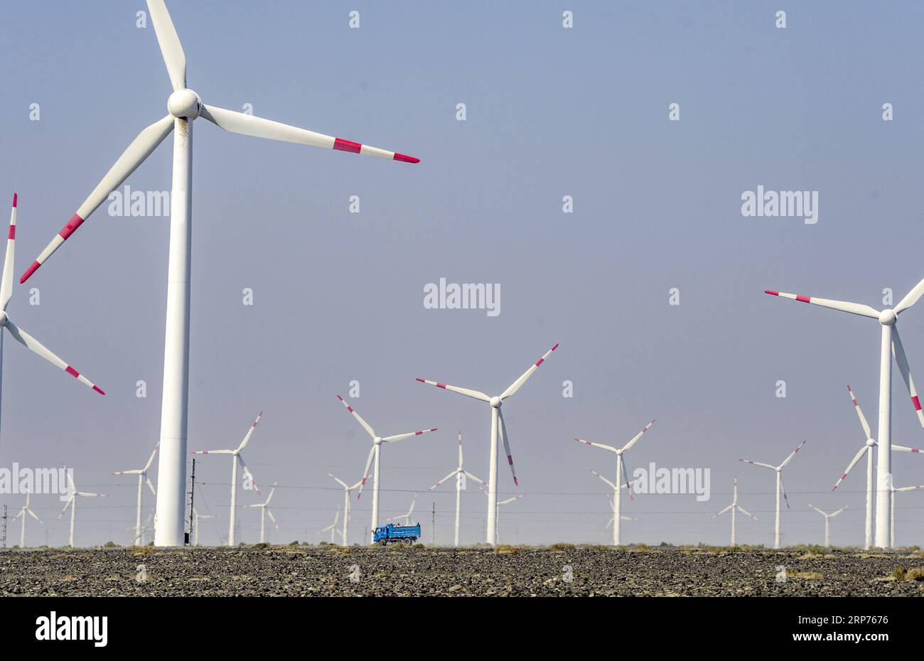 (190129) -- BEIJING, Jan. 29, 2019 (Xinhua) -- A vehicle runs across a wind power plant in Urumqi, northwest China s Xinjiang Uygur Autonomous Region, Sept. 18, 2018. New energy power generation saw double digit growth last year in northwest China s Xinjiang Uygur Autonomous Region amid efforts to reduce coal consumption to improve the energy mix. Wind and solar power generation rose 15.2 percent and 13.6 percent to 36 billion kwh and 11.7 billion kwh respectively, according to the regional development and reform commission. It said 22.9 percent of installed wind power generating capacity and Stock Photo