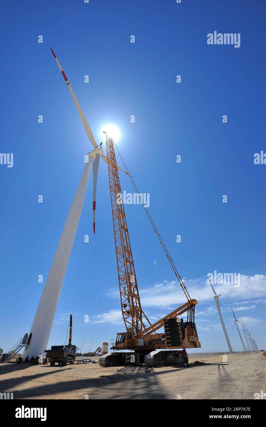(190129) -- BEIJING, Jan. 29, 2019 (Xinhua) -- Workers install a wind turbine at the wind energy base of Hami in northwest China s Xinjiang Uygur Autonomous Region, June 5, 2015. New energy power generation saw double digit growth last year in northwest China s Xinjiang Uygur Autonomous Region amid efforts to reduce coal consumption to improve the energy mix. Wind and solar power generation rose 15.2 percent and 13.6 percent to 36 billion kwh and 11.7 billion kwh respectively, according to the regional development and reform commission. It said 22.9 percent of installed wind power generating c Stock Photo