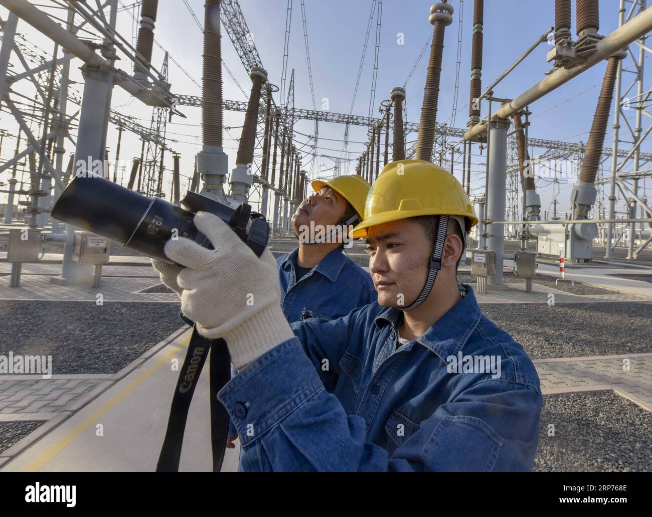 (190129) -- BEIJING, Jan. 29, 2019 (Xinhua) -- Staff members check the facilities at a transformer substation in Turpan, northwest China s Xinjiang Uygur Autonomous Region, Sept. 18, 2018. New energy power generation saw double digit growth last year in northwest China s Xinjiang Uygur Autonomous Region amid efforts to reduce coal consumption to improve the energy mix. Wind and solar power generation rose 15.2 percent and 13.6 percent to 36 billion kwh and 11.7 billion kwh respectively, according to the regional development and reform commission. It said 22.9 percent of installed wind power ge Stock Photo