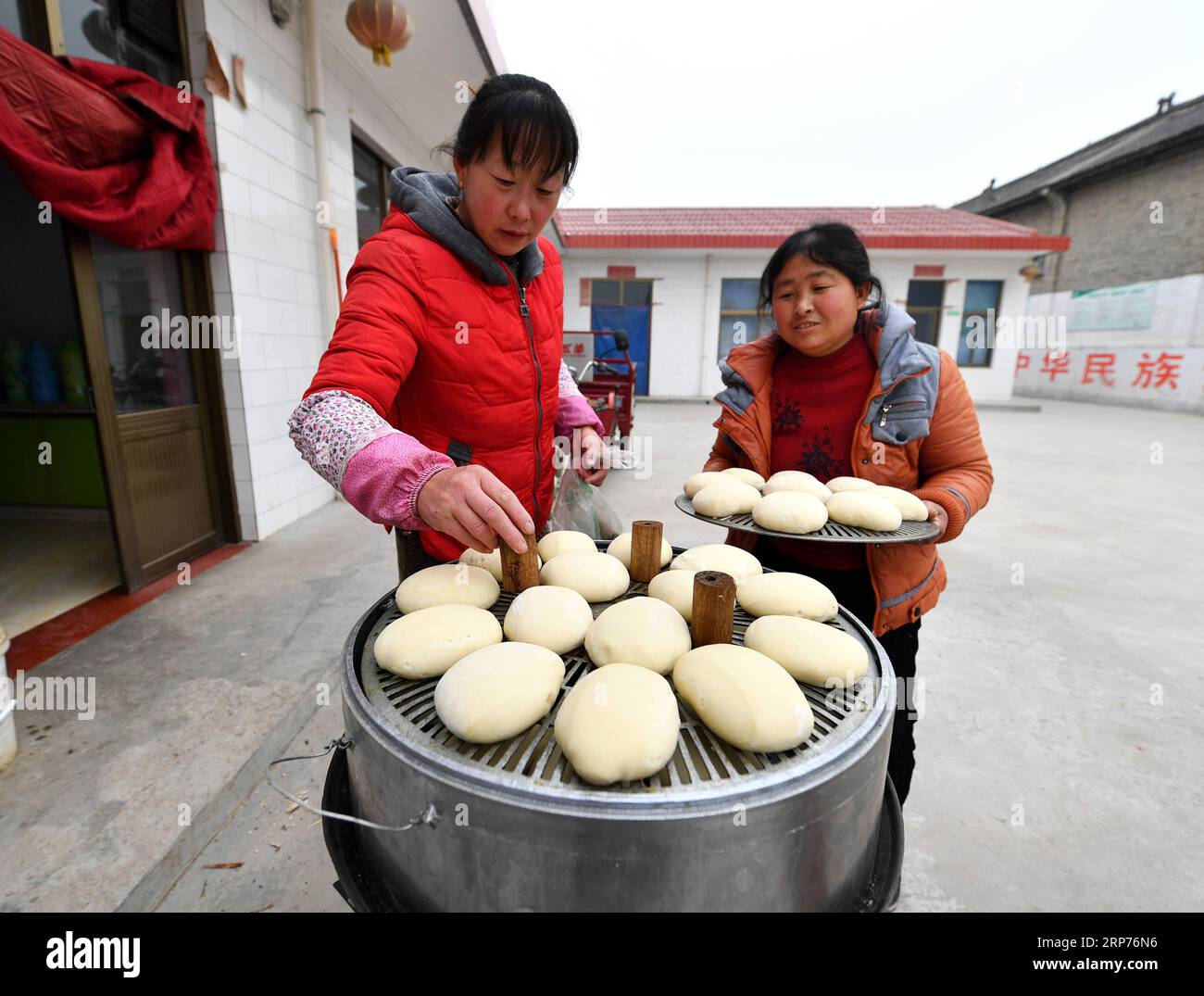 (190129) -- WENXI COUNTY, Jan. 29, 2019 (Xinhua) -- Residents of the Home of Happiness poverty-alleviation settlement cook steamed bread in Zhangcailing Village of Yangyu Township, Wenxi County, north China s Shanxi Province, Jan. 25, 2019. For generations, residents of Zhangcailing Village barely scraped a living as a result of geographical isolation, poor infrastructure and lack of supporting industries. To help pull villagers out of poverty, the government increased its financial support encouraging agriculture and husbandry suited to the local conditions. By planting Sichuan pepper, a spic Stock Photo
