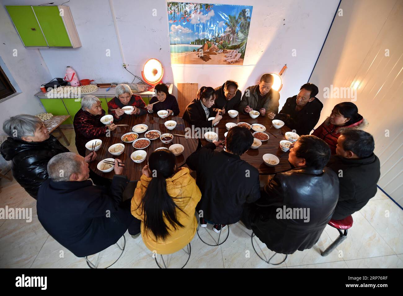 (190129) -- WENXI COUNTY, Jan. 29, 2019 (Xinhua) -- Residents of the Home of Happiness poverty-alleviation settlement have a meal together in Zhangcailing Village of Yangyu Township, Wenxi County, north China s Shanxi Province, Jan. 28, 2019. For generations, residents of Zhangcailing Village barely scraped a living as a result of geographical isolation, poor infrastructure and lack of supporting industries. To help pull villagers out of poverty, the government increased its financial support encouraging agriculture and husbandry suited to the local conditions. By planting Sichuan pepper, a sp Stock Photo