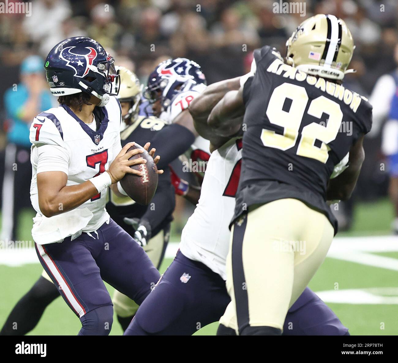 New Orleans, USA. 27th Aug, 2023. Houston Texans quarterback C.J. Stroud  (7) attempts a pass while facing a heavy pass rush from New Orleans Saints  defensive ends Tanoh Kpassagnon (92) and Carl