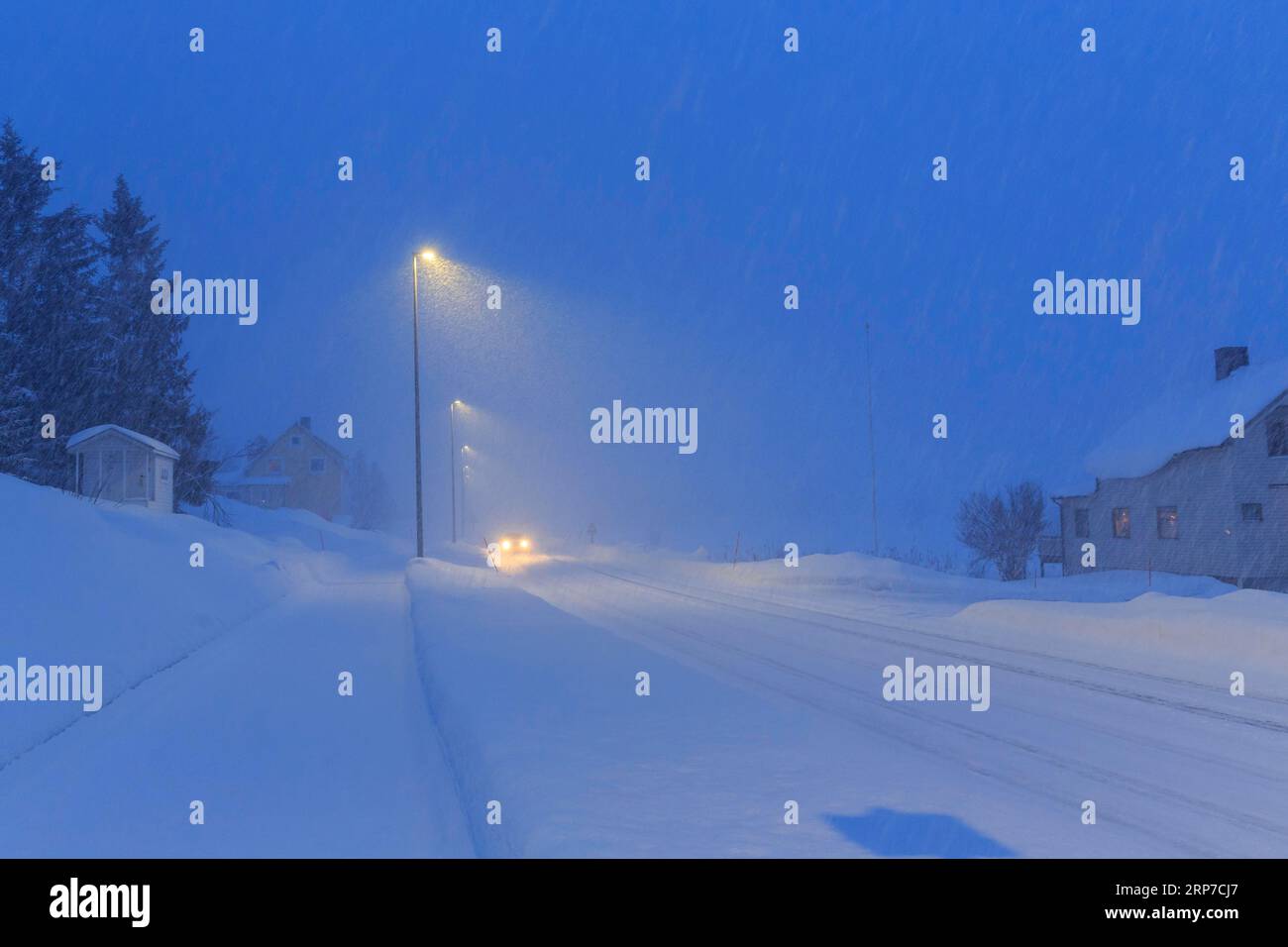 Winter road in driving snow, twilight, Finnsnes, Troms og Finnmark, Norway Stock Photo