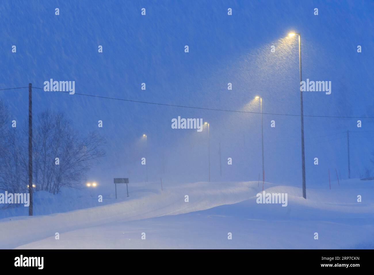 Winter road in driving snow, twilight, Finnsnes, Troms og Finnmark, Norway Stock Photo