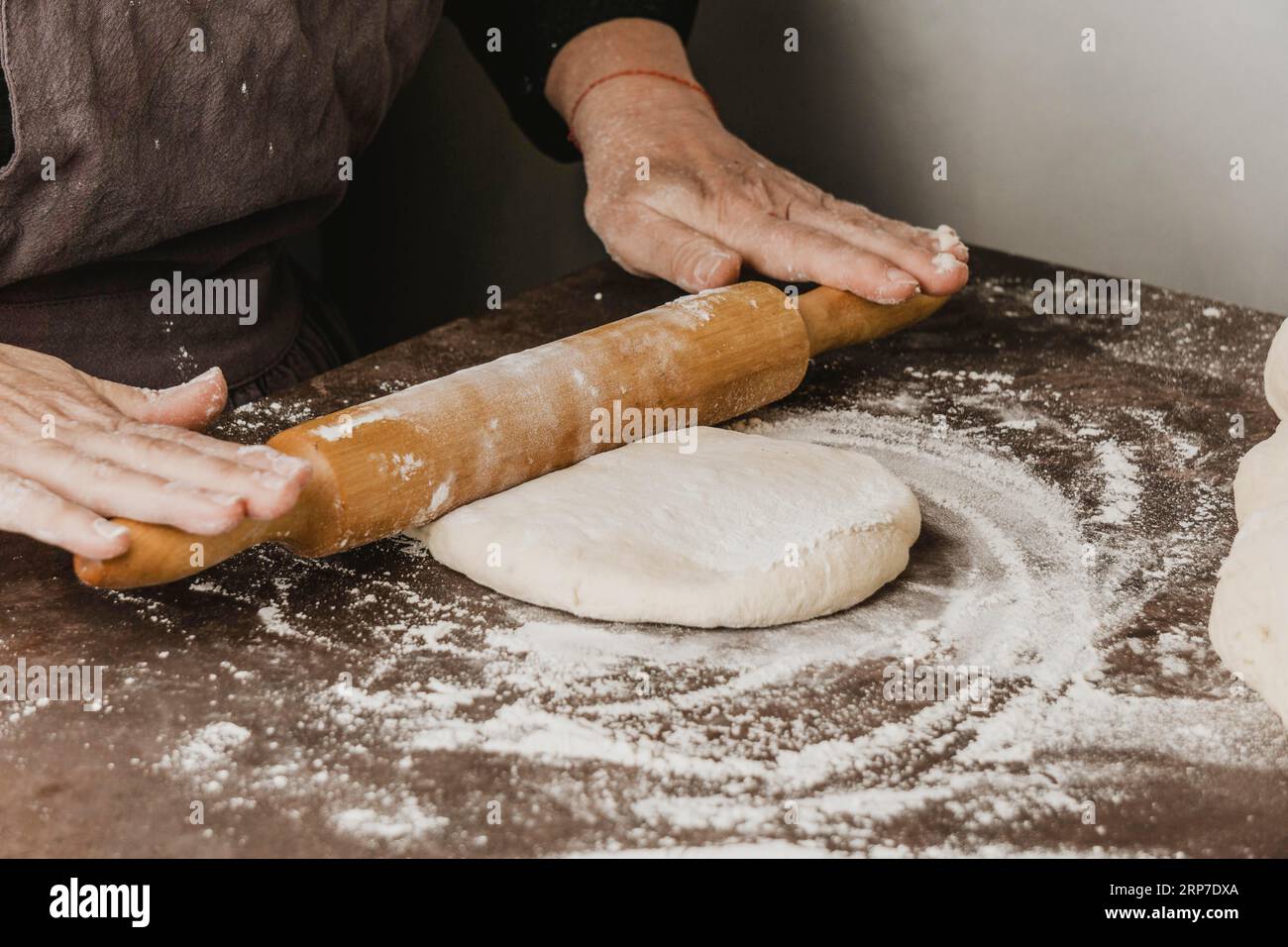 Female chef using rolling pin pizza dough Stock Photo