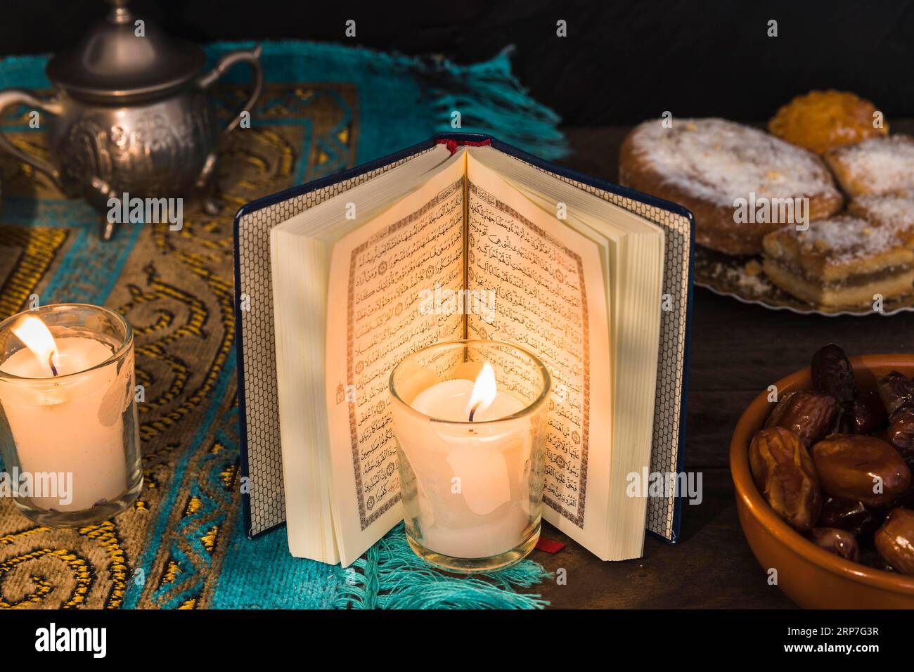 Candle arabic book near desserts Stock Photo Alamy