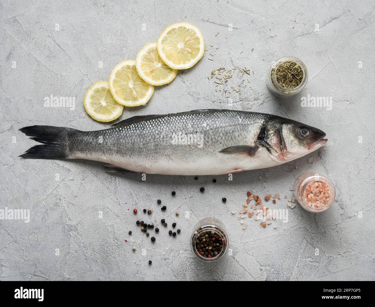 Flat lay fish lemon spices Stock Photo - Alamy